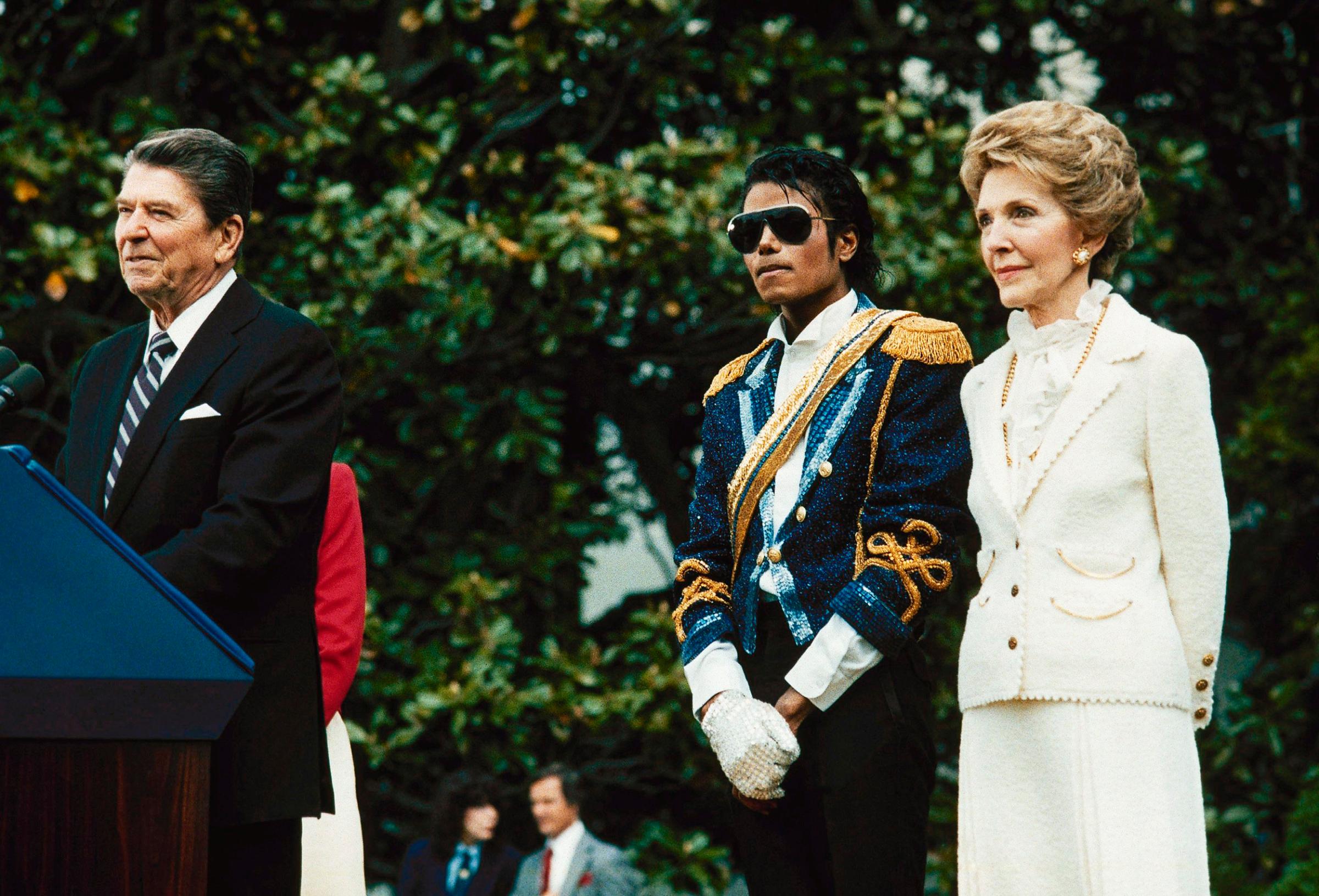 Michael Jackson stands with former President Ronald Reagan and first lady Nancy Reagan on the south lawn of the White House prior to receiving an award from the president for his contribution to the drunk driving awareness program in Washington, DC on May 14, 1984.