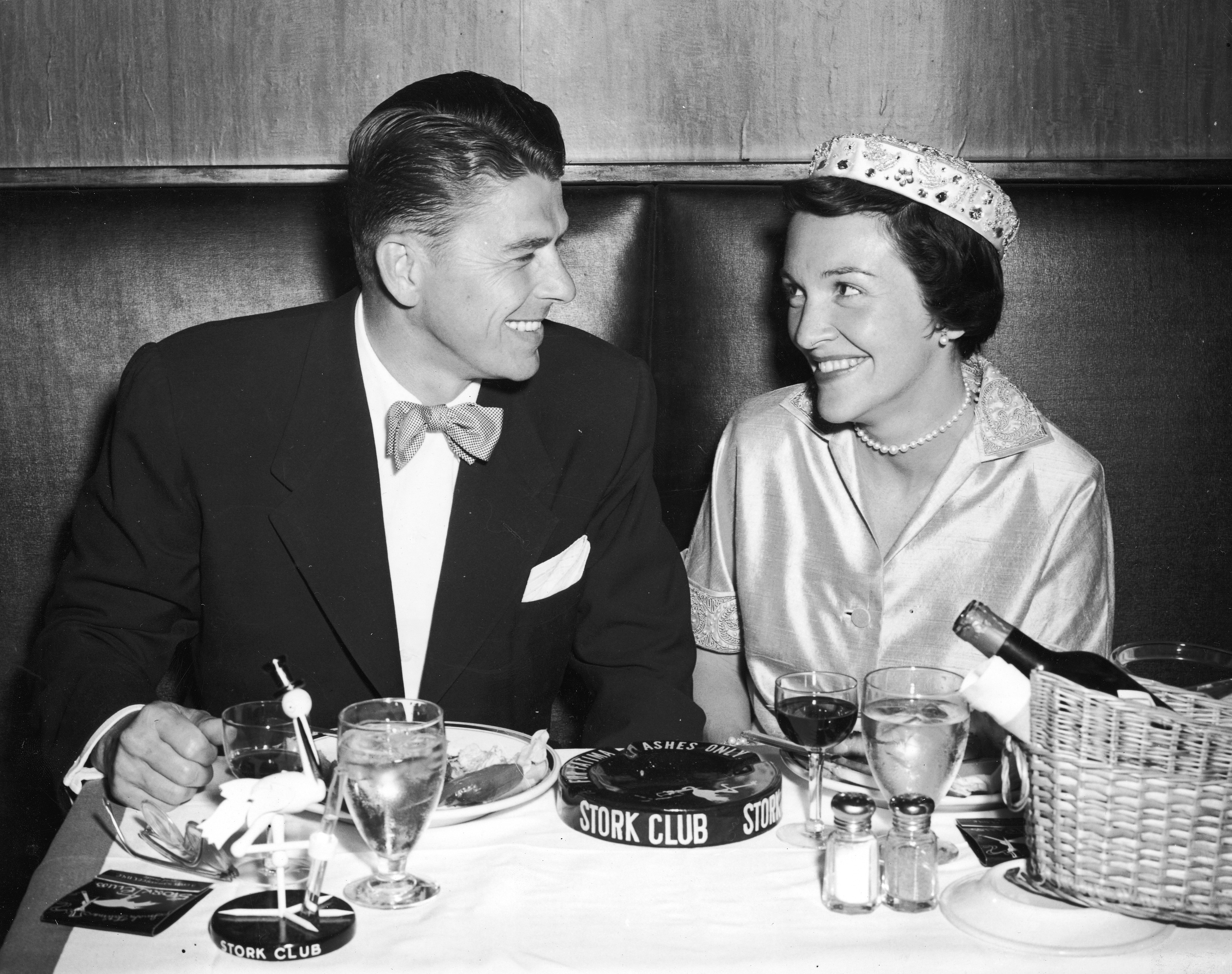 Ronald Reagan and his wife Nancy Reagan smile during their honeymoon dinner at the Stork Club in New York in 1952.
