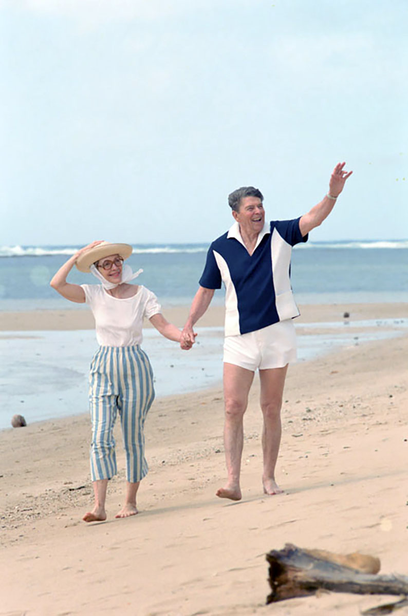 President Ronald Reagan and Nancy Reagan walk along a beach at Kahala at the Hemmeter residence in Honolulu on April 27, 1986.