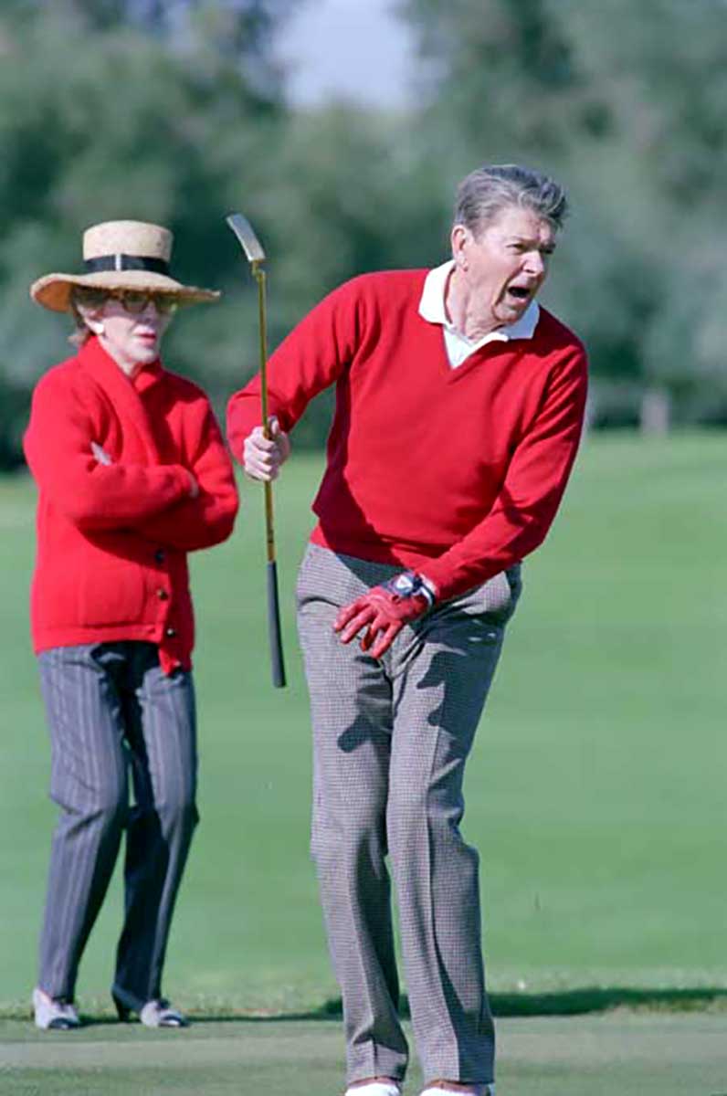 President Ronald Reagan plays golf as wife Nancy Reagan watches at Sunnylands Annenberg Estate in Rancho Mirage, Calif. on Dec. 31, 1988.