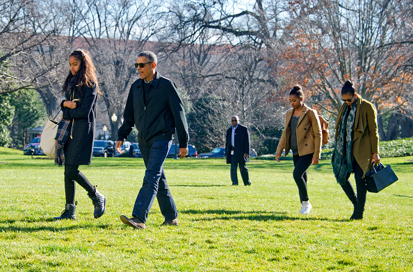 U.S. President Barack Obama and his family (L-R) Malia, Sasha, and first lady Michelle Obama return to the South Lawn of the White House on Jan. 3 in Washington, DC. (Ron Sachs—Pool/Getty Images)
