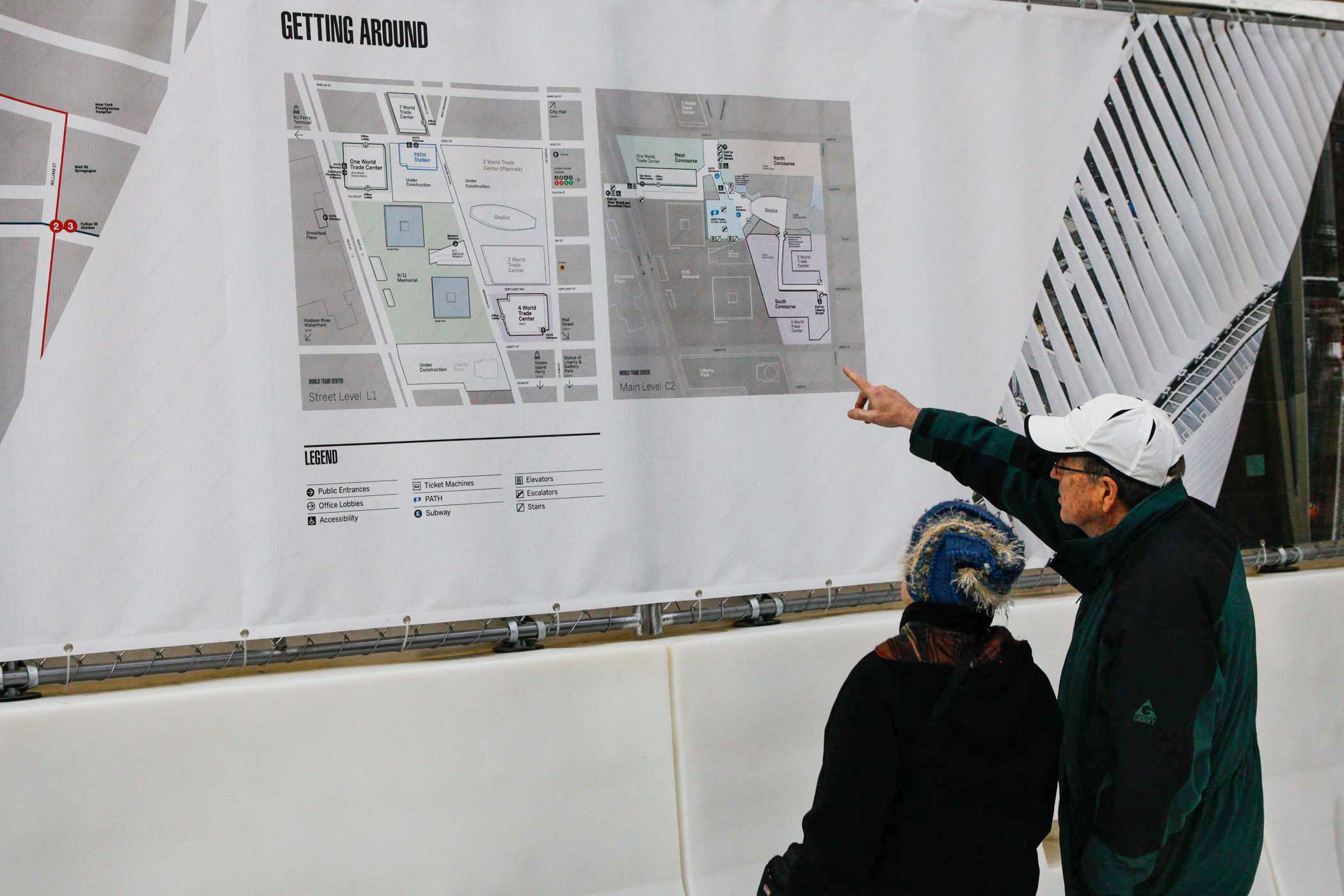 People inspect a map on the wall of downtown New York.