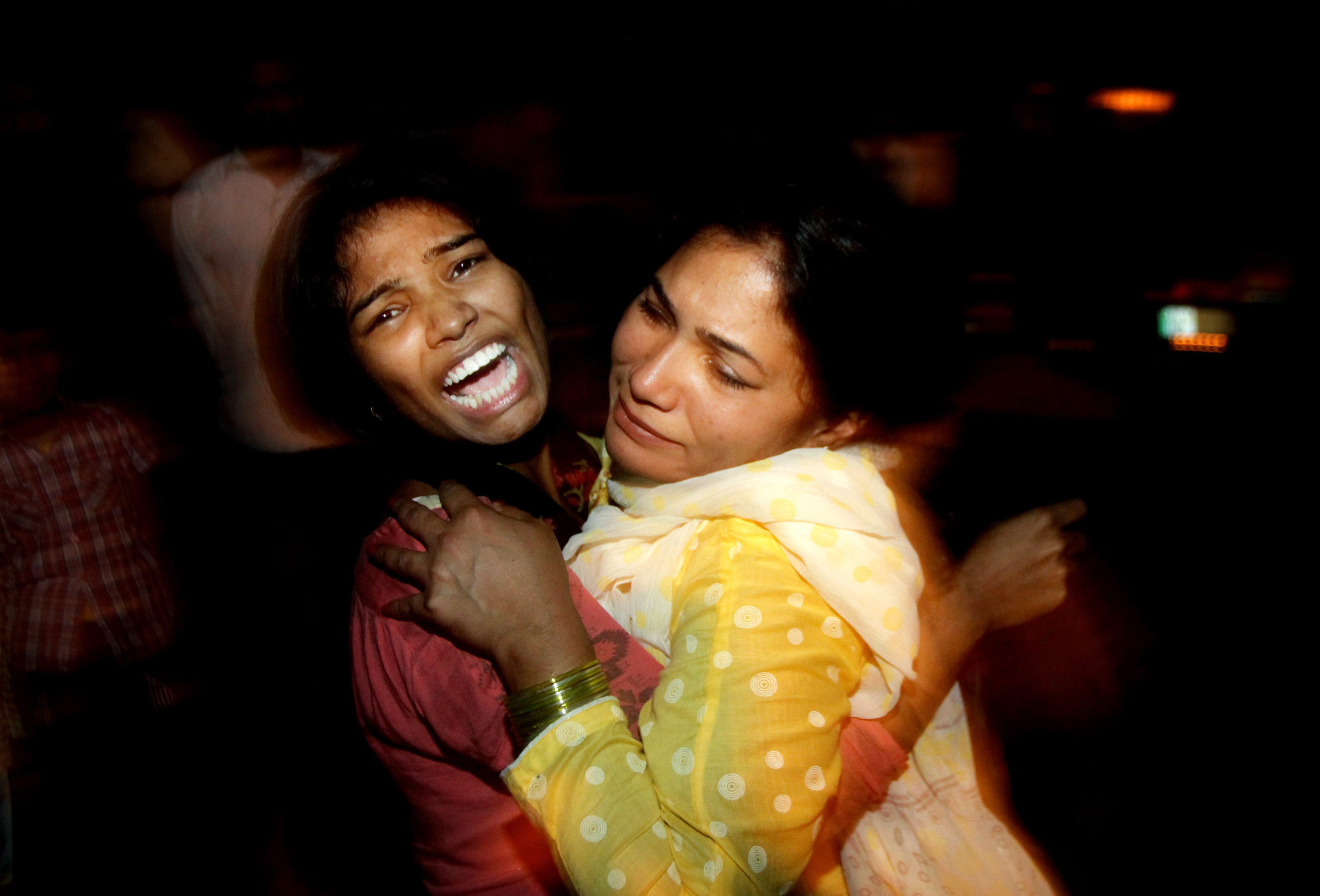 Women comfort each other as they mourn over the death of a family member who was killed in a bomb blast, at a local hospital in Lahore, Pakistan, on March, 27, 2016. (K.M. Chaudary—AP)