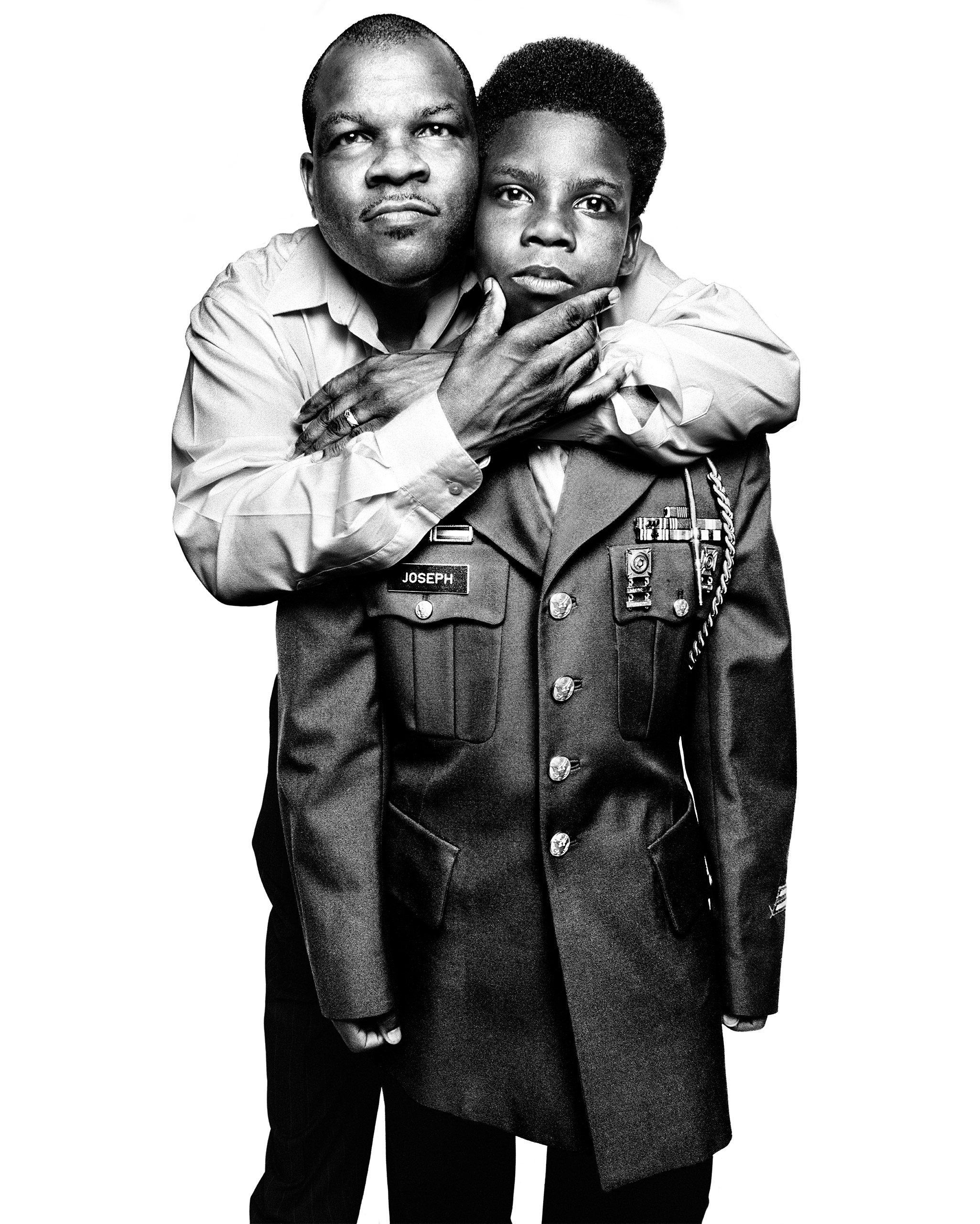 Hilarion Warren Joseph, a decorated veteran of the first Gulf War, with his son,
                              Japeri, who wears the jacket from Joseph’s US Army uniform. Joseph returned
                              from war suffering from post-traumatic stress disorder and attempted suicide
                              three times. New York City, 2013.