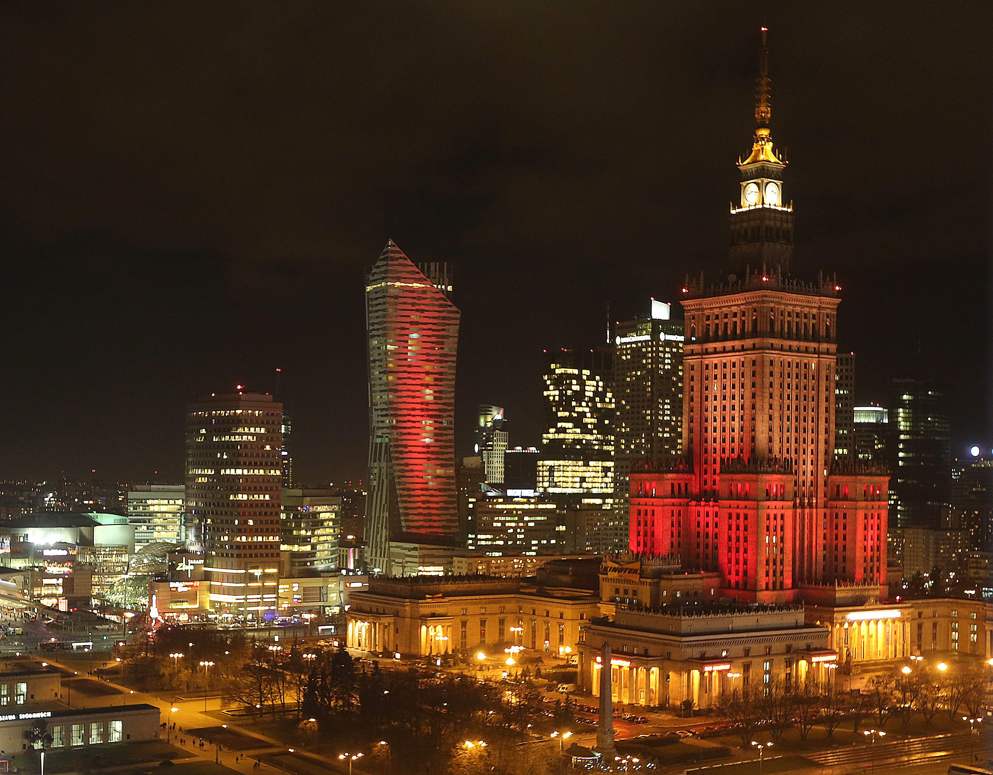 The Palace of Culture, right, is lit in the colors of the Belgian flag on March 22, 2016 in Warsaw, Poland.