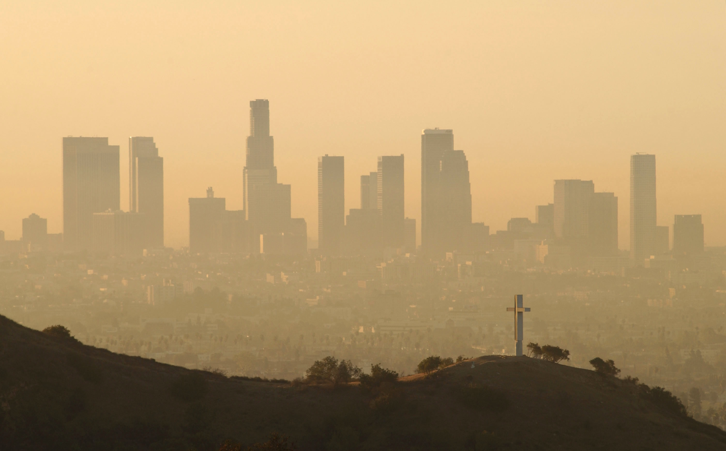 Downtown highrise buildings are shown cloaked in dirty air shortly after sunrise Sept. 11, 2002 in Los Angeles, California. (David McNew—Getty Images)