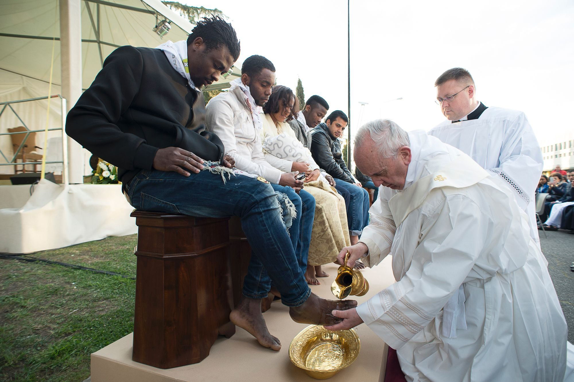 In this handout picture released by the Vatican Press Office, Pope Francis performs the foot-washing ritual at the Castelnuovo di Porto refugees center near Rome, Italy on March 24, 2016. Pope Francis washed the feet of 11 young asylum seekers and a worker at their reception centre to highlight the need for the international community to provide shelter to refugees.