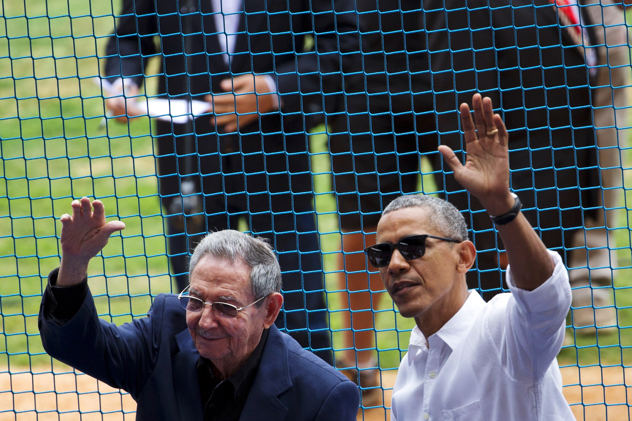 U.S. President Barack Obama, right, and Cuban President Raul Castro wave to fans as they arrive for a baseball game between the Tampa Bay Rays and the Cuban national baseball team in Havana on Tuesday, March 22, 2016.