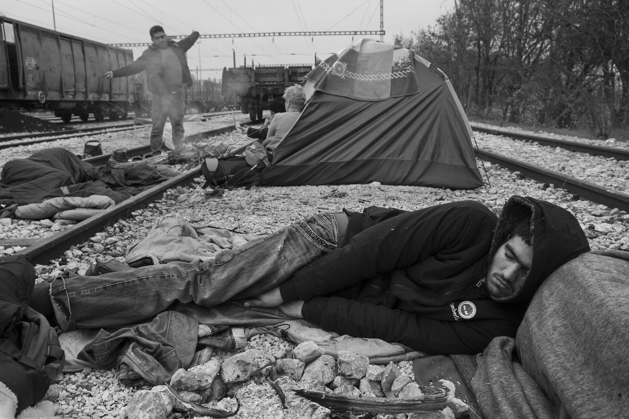 A man sleeps at a camp for refugees near the border town of Idomeni in Greece. Thousands are  stranded in Greece because of border closures in the Balkans, March 17, 2016.
