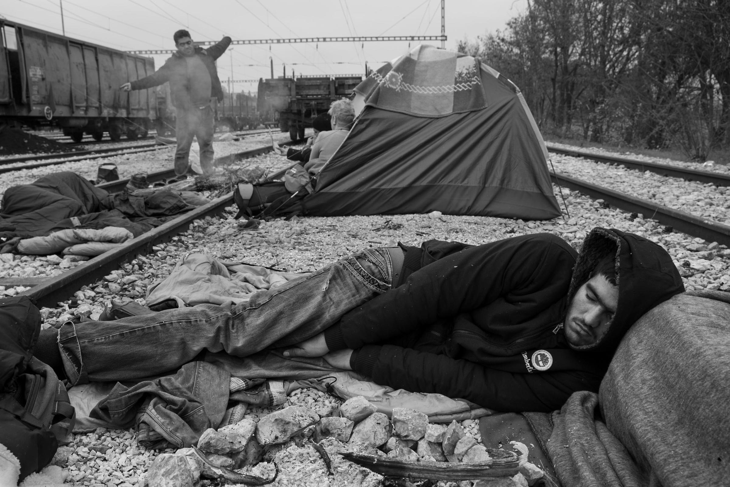 A man sleeps at a camp for refugees near the border town of Idomeni in Greece. Thousands are stranded in Greece because of border closures in the Balkans, March 17, 2016.