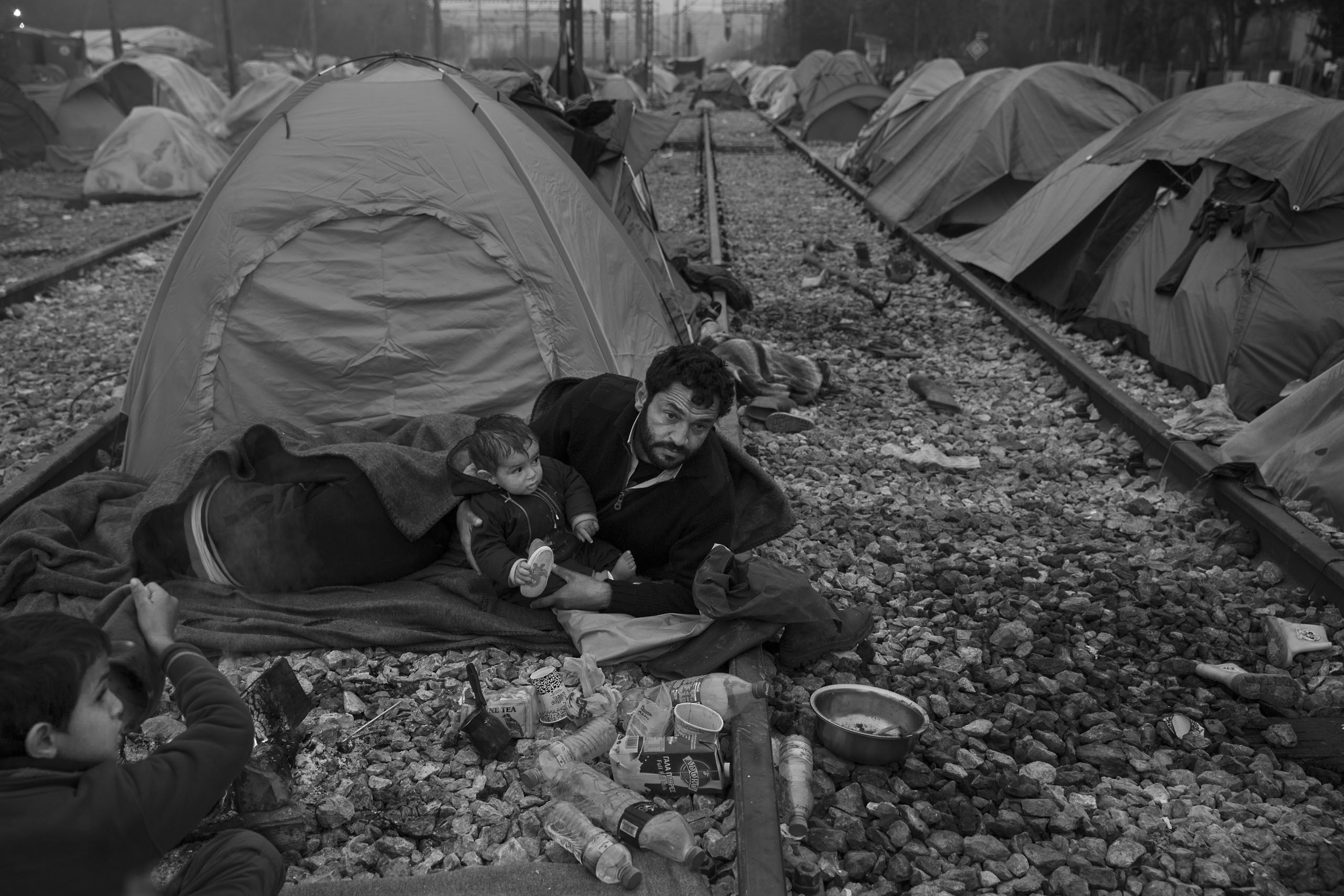 Refugees live in  tents along the railroad tracks at a camp  near Idomeni, Greece at the border with Macedonia, where thousands are stranded in the rain, mud and the cold with insufficient food and medical care, March 17, 2016.
