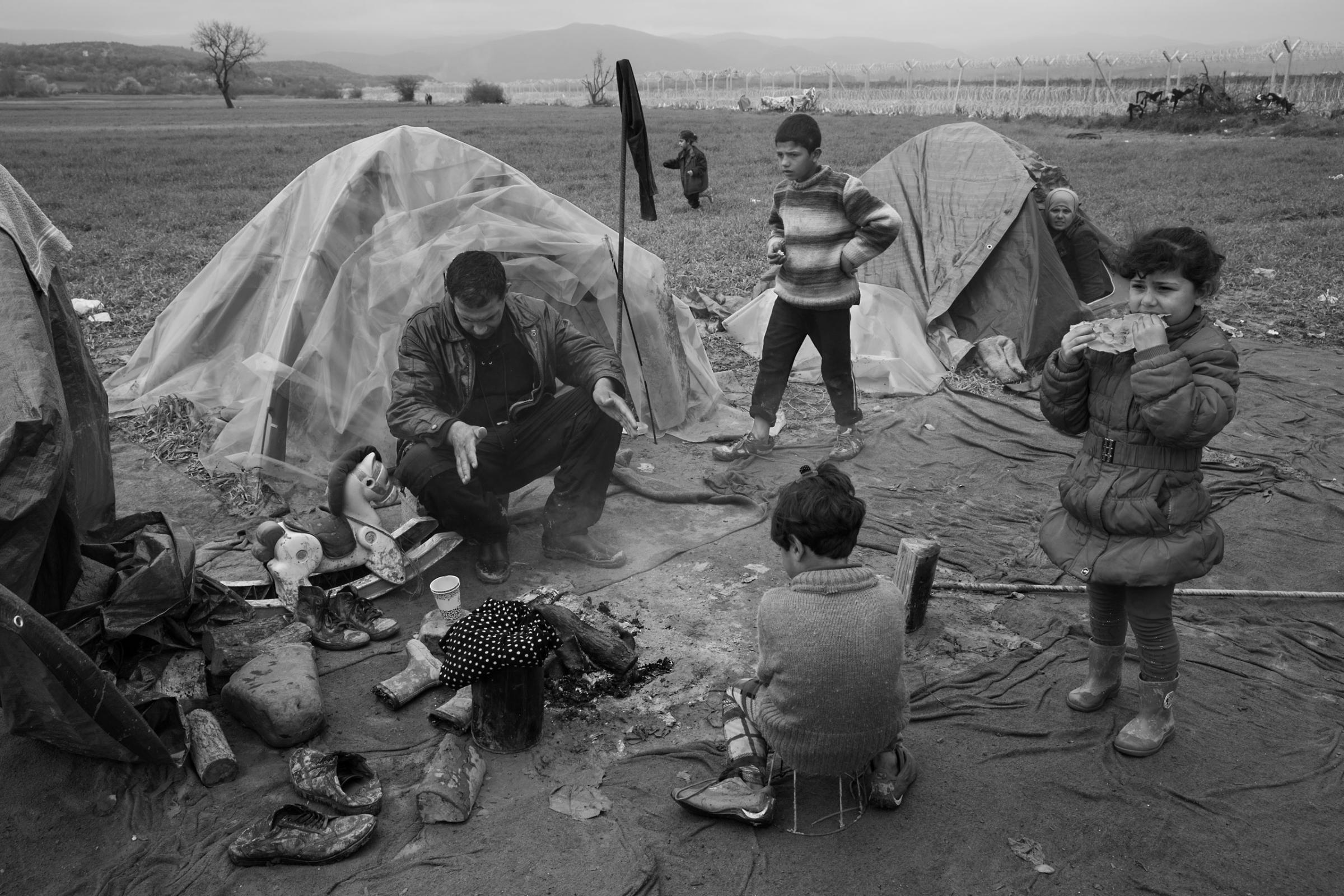 Thousands of refugees are stranded in a "no-mans land" camp at border of Greece and Macedonia near the town of Idomeni. Since it was created around railway tracks last summer, conditions have grown increasingly unlivable, with shortages of food, toilets and health care, as well as beds. The camp’s inhabitants cook their meals over bonfires of plastic and other trash, March 17, 2016.