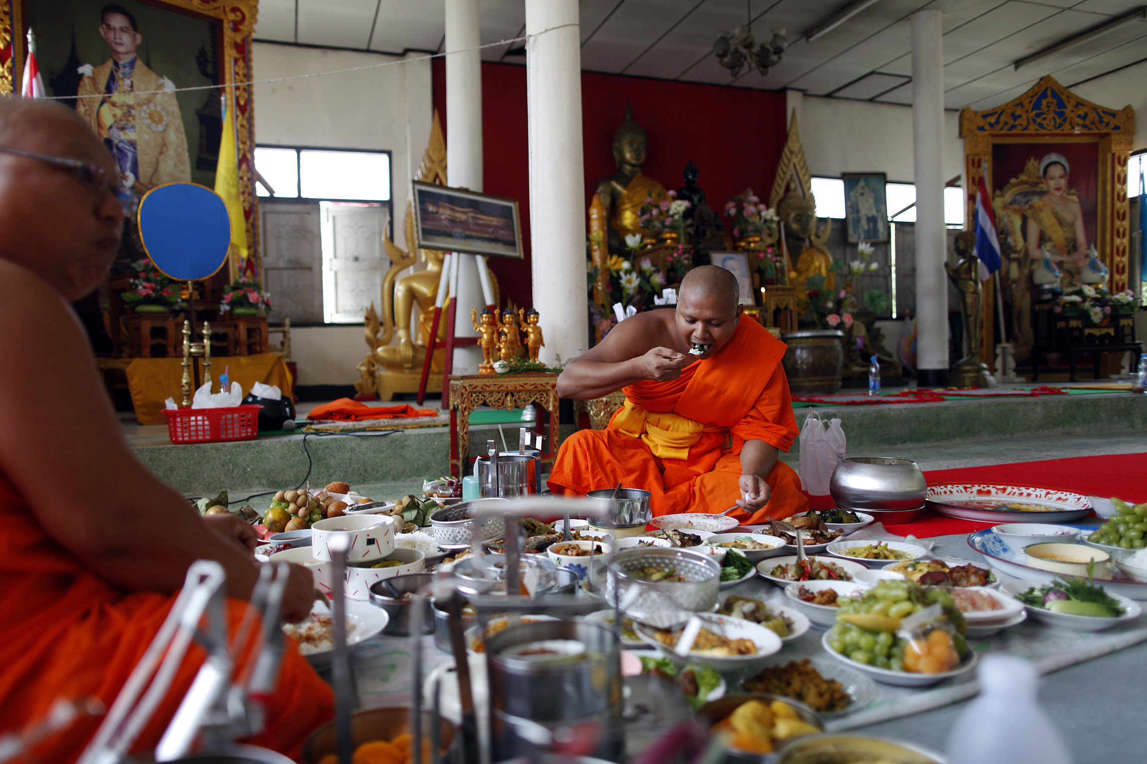Buddhist monks are offered food during a ceremony at their temple where a Thai army unit is also based in the troubled Yala province in southern Thailand