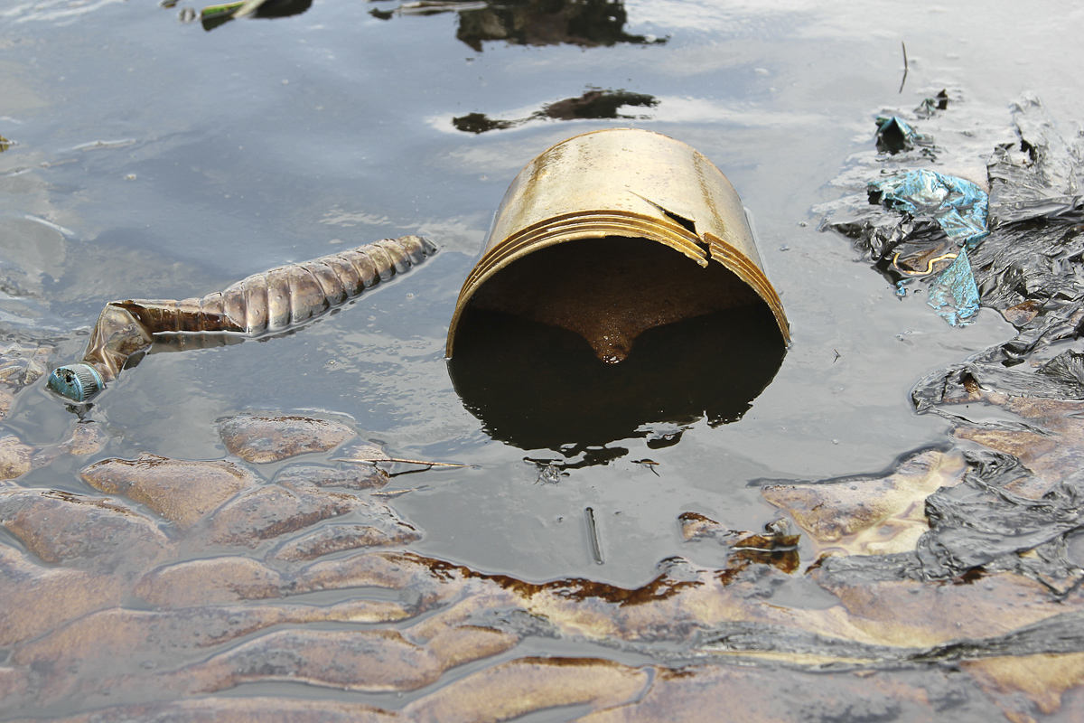 Crude oil flows at the banks of a river, after a Shell pipeline leaked, in the Oloma community in Nigeria's delta region