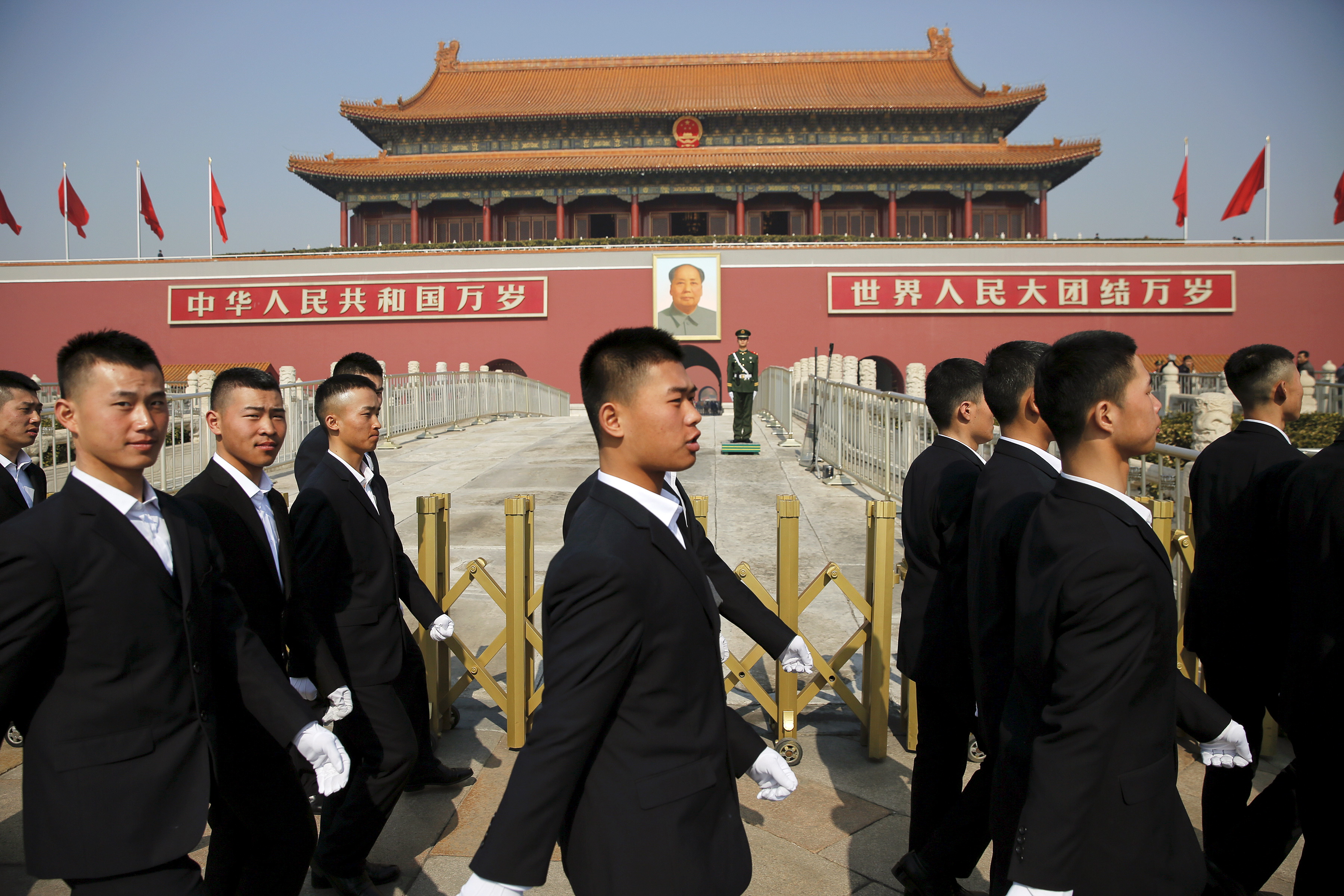 Security personnel march in front of Tiananmen Gate as the area near the Great Hall of the People prepares for upcoming annual sessions of the National People's Congress (NPC) and Chinese People's Political Consultative Conference (CPPCC), in Beijing