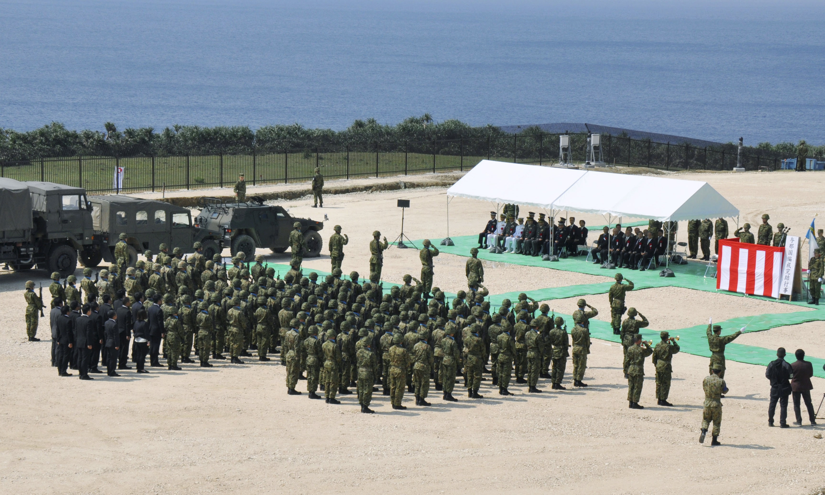 Members of Japan's Self Defence Force hold an opening ceremony of a new military base on the island of Yonaguni