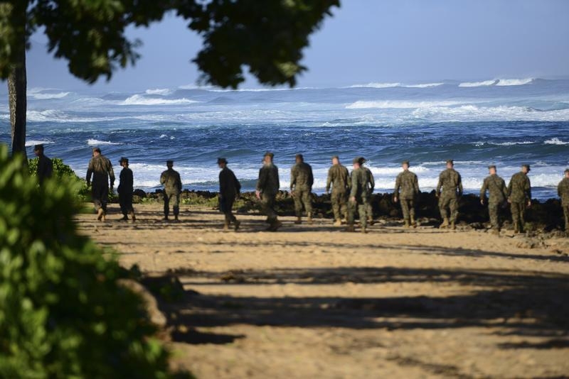 Marines scour a Hawaiian beach in January, seeking evidence of a midair collision between two Marine choppers that killed 12. (Coast Guard photo / Petty Officer 1st Class Levi Read / via Reuters)