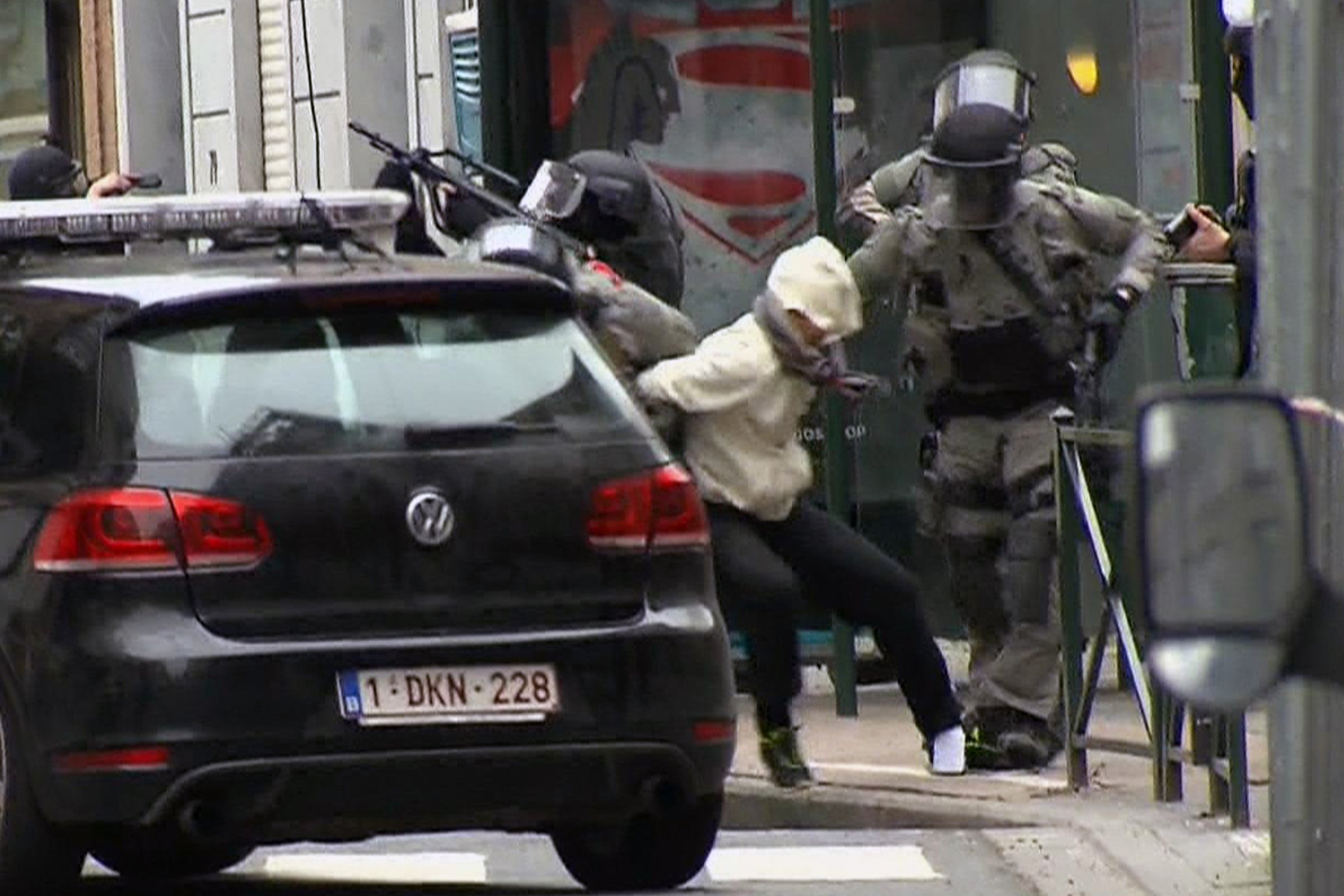 In this framegrab taken from VTM, something appears to drop from inside the pant leg of Salah Abdeslam as he is arrested by police during a raid in the Molenbeek neighborhood of Brussels, Belgium, March 18, 2016.