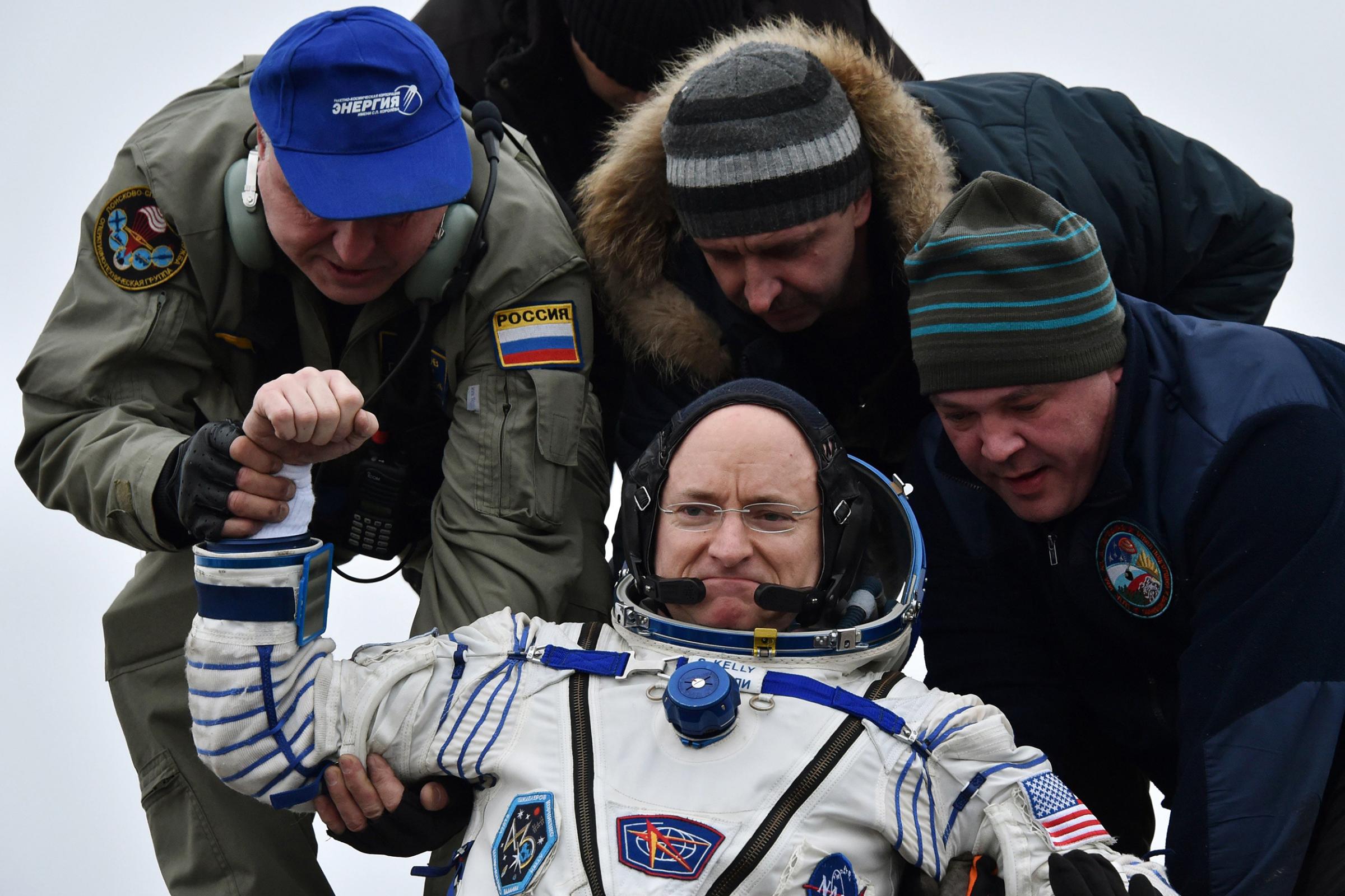 Ground personnel help Scott Kelly get off the Soyuz TMA-18M space capsule after landing in Kazakhstan on March 2, 2016.