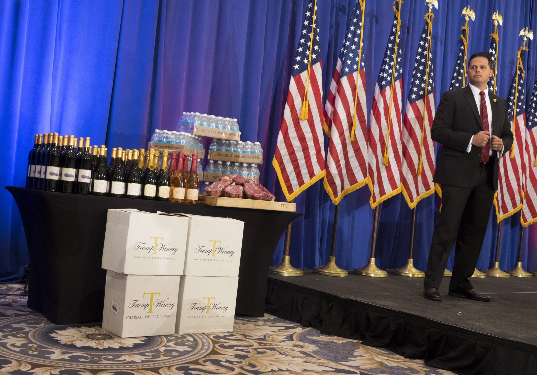 A security guard stands next to a display of meat, wine and water beside the podium Republican presidential candidate Donald Trump before a news conference at the Trump National Golf Club Jupiter on March 8 in Jupiter, Fla.