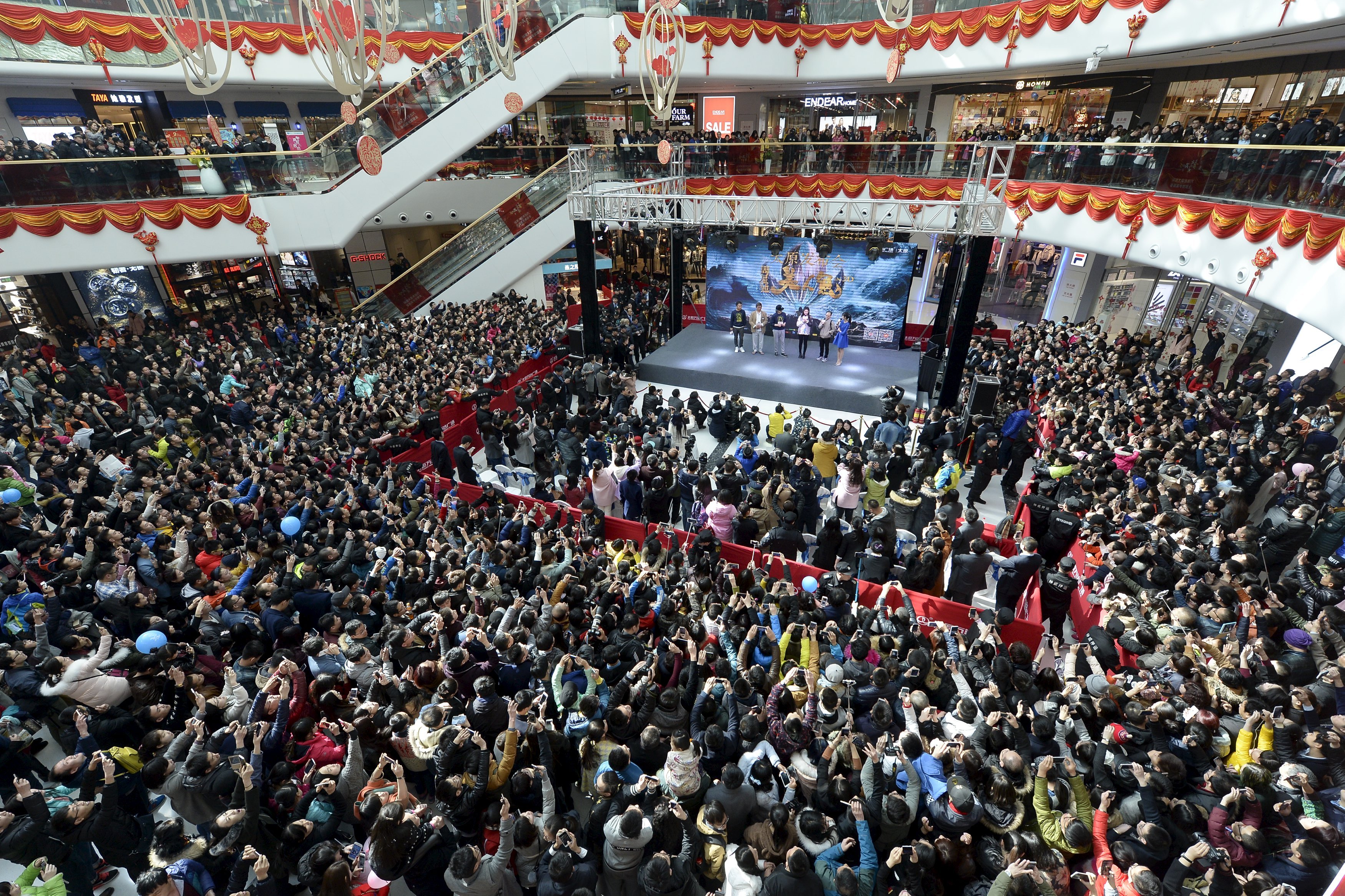 People attend a promotional event with Hong Kong star Stephen Chow for the film, The Mermaid, in Taiyuan, China, on Feb. 17, 2016. (China Daily/Reuters)