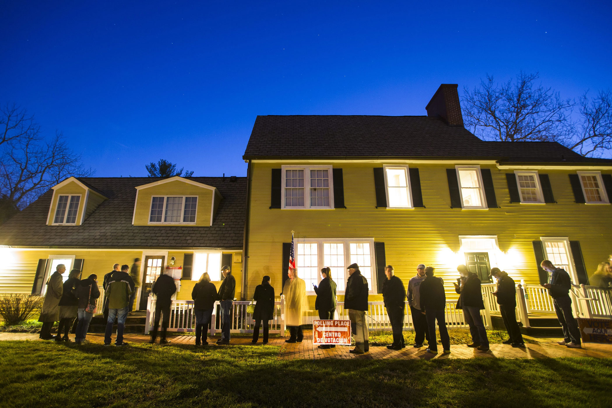 Virginia residents wait in line in the pre-dawn hours to vote in the Virginia primary at a historic property called the Hunter House at Nottoway Park in Vienna, Va.