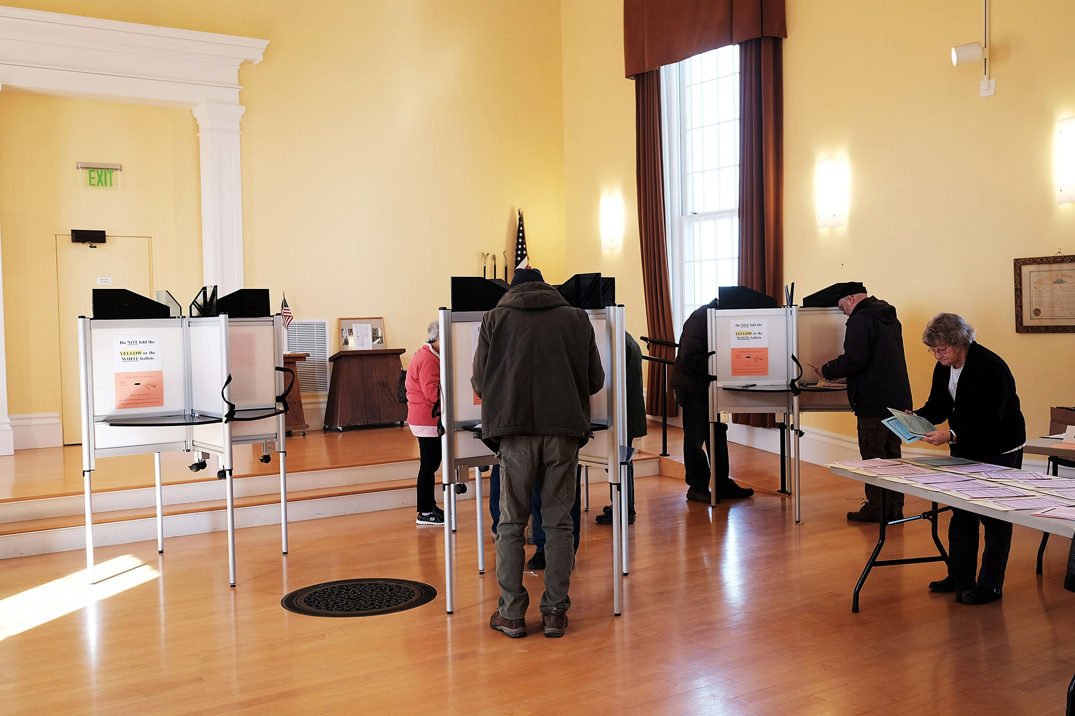 People vote in a church being used as a polling station on Tuesday, March 1, 2016 in Ferrisburgh, Vt.