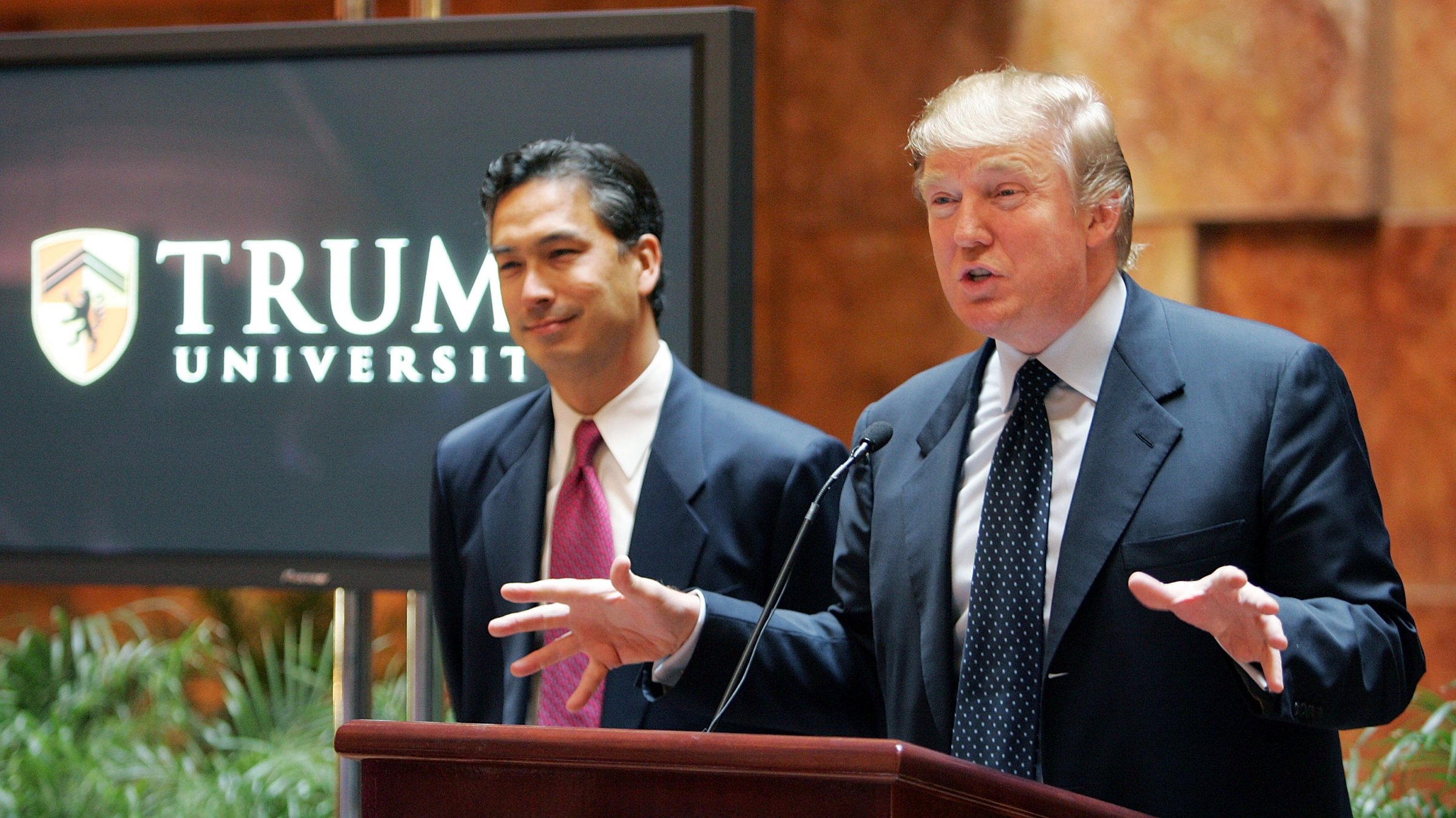 Donald Trump (R) speaks as university president Michael Sexton (L) looks on during a news conference announcing the establishment of Trump University May 23, 2005 in New York City.