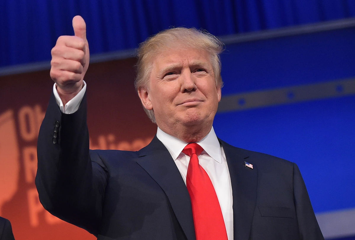 Donald Trump flashes the thumbs-up as he arrives on stage for the start of a Republican presidential debate on Aug. 6, 2015, in Cleveland, Ohio. (Mandel Ngan—AFP/Getty Images)