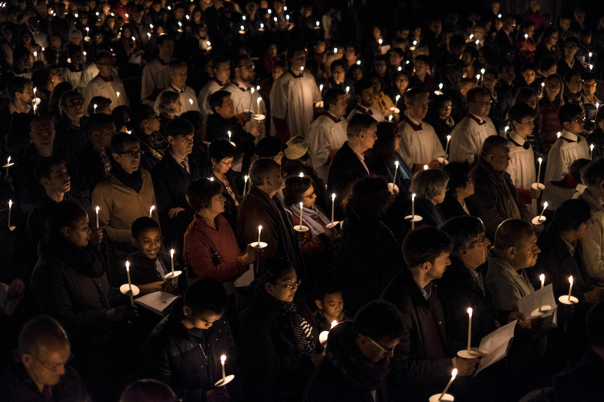 People hold candles during The Easter Vigil service on the evening of Holy Saturday at Westminster Cathedral on April 4, 2015 in London (David Levenson—Getty Images)