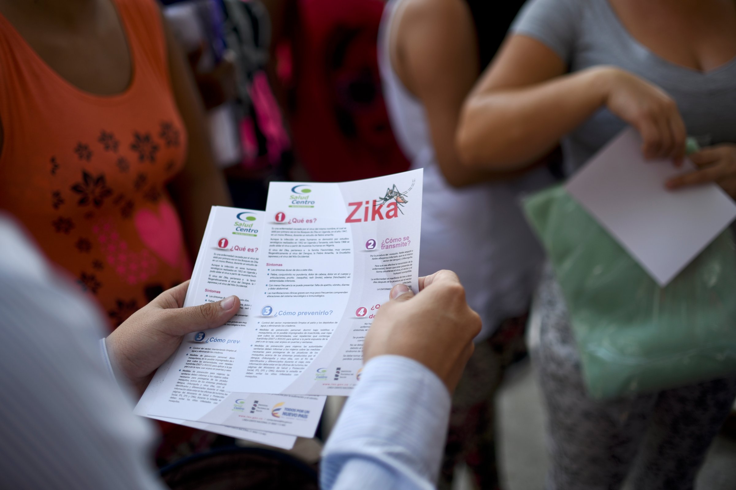 An official of the of Health Ministry delivers brochures with information about the Zika virus to pregnant women, on Feb. 10, 2016, in Cali, Colombia.