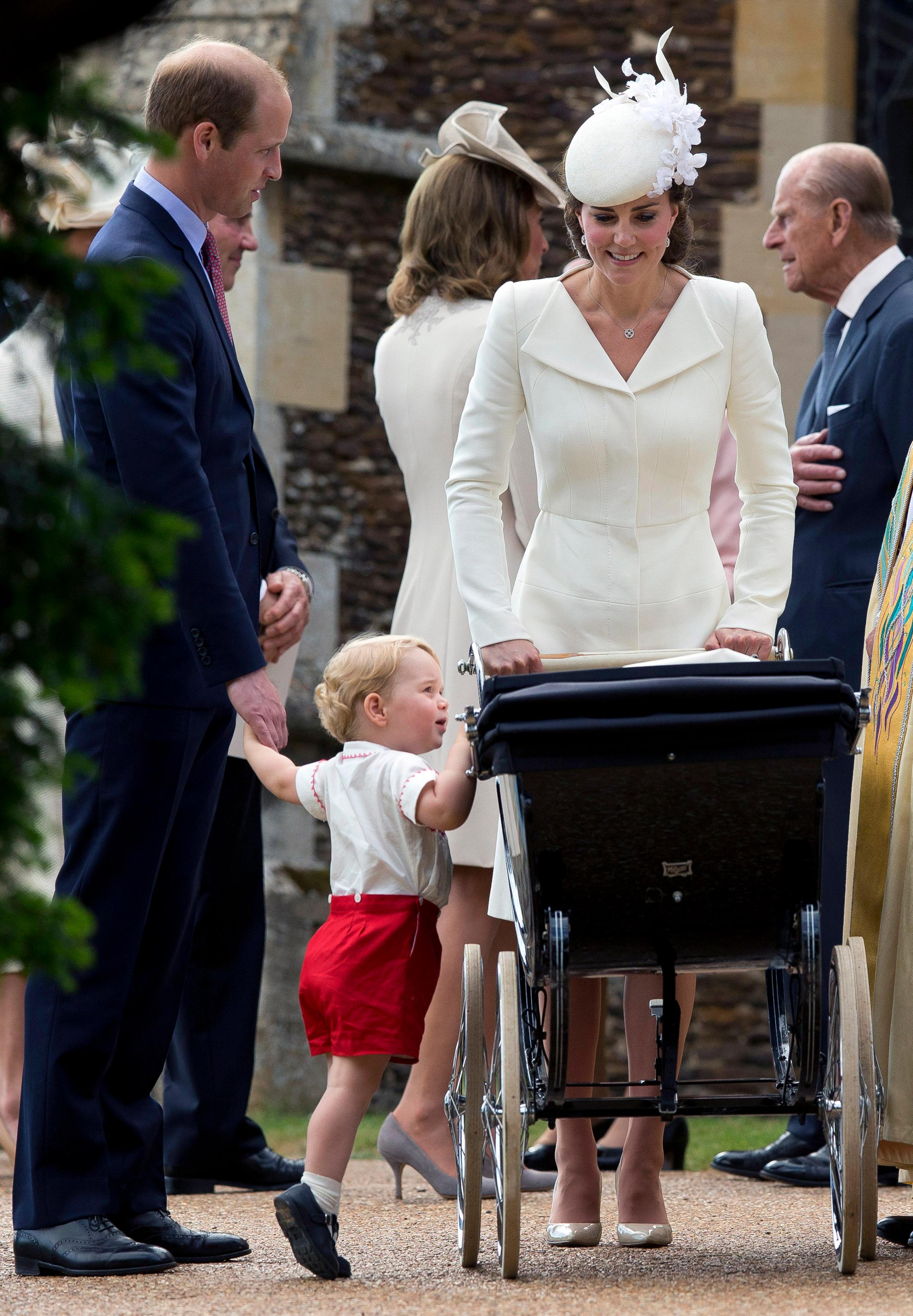 Catherine, Duchess of Cambridge, Prince William, Duke of Cambridge, Princess Charlotte of Cambridge and Prince George of Cambridge leave the Church of St Mary Magdalene on the Sandringham Estate after the Christening of Princess Charlotte of Cambridge in King's Lynn, England on July 5, 2015.