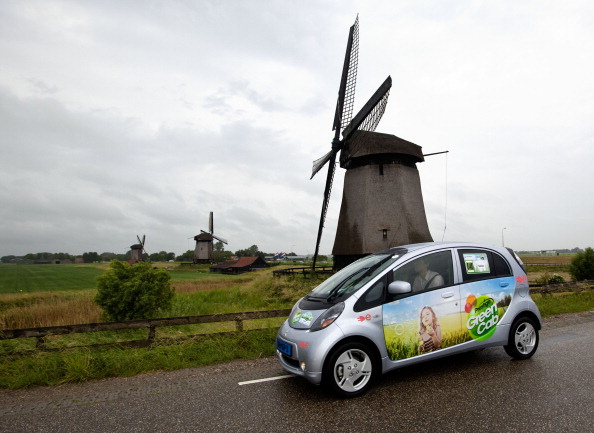 A Mitsubishi i-MiEv drives past Dutch windmills in the 2011 Electric Car Rally as part of World Environment Day activities on June 5, 2011 near Zaandam, The Netherlands. (Michel Porro—Getty Images)