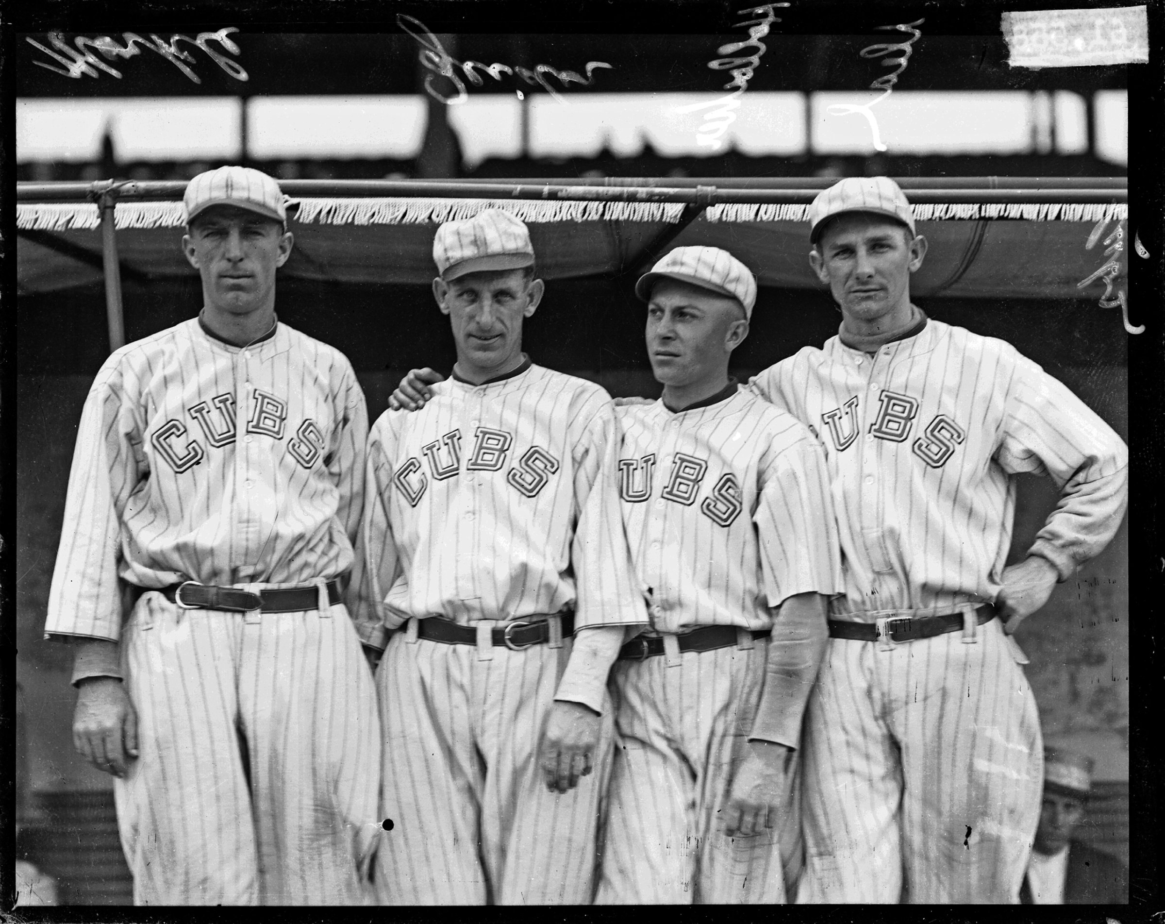 Chicago Cubs baseball players Merkle, Zeider, Charles Hollocher, and Deal standing in front of a dugout at Weeghman Park, Chicago, Illinois, 1918.