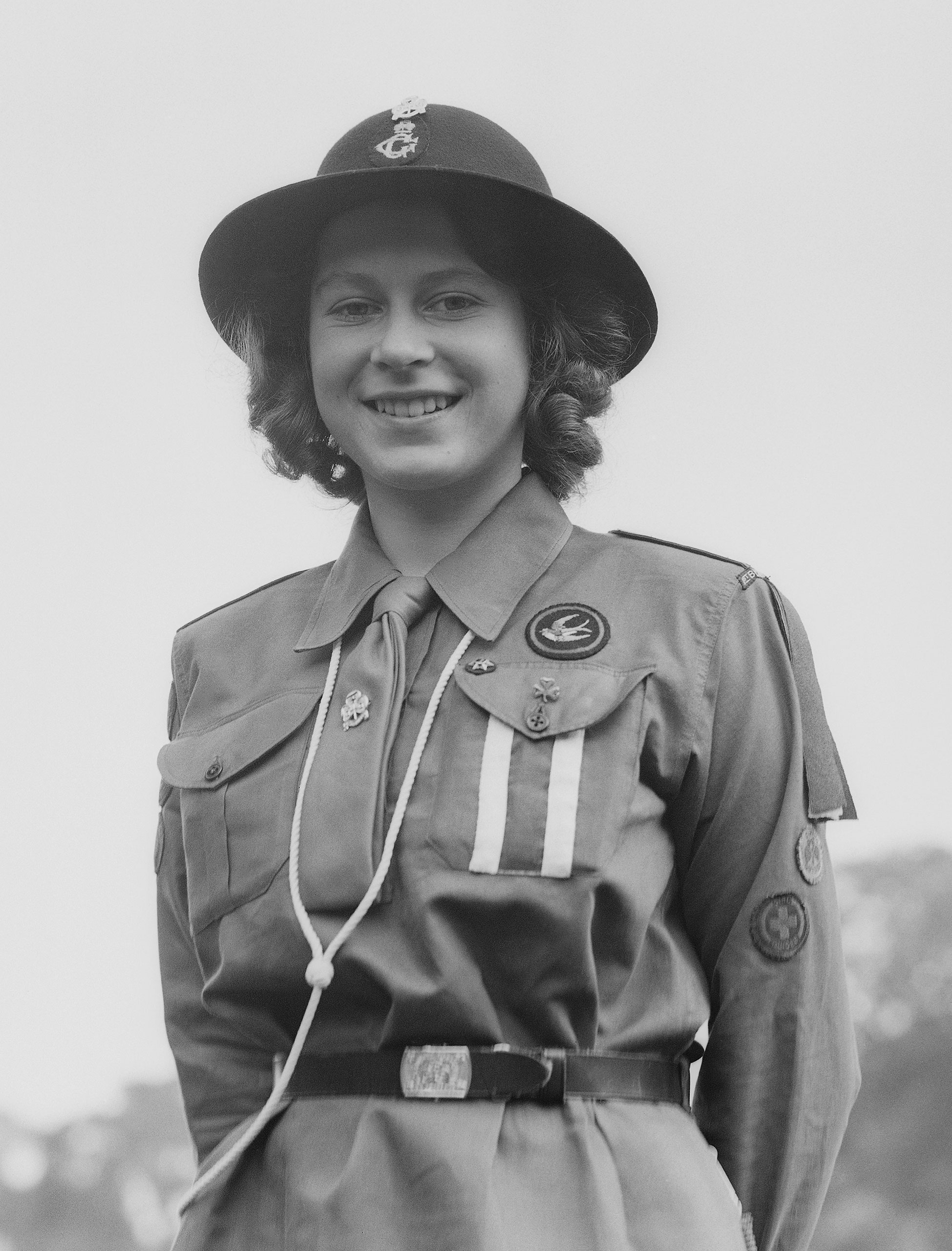 Princess Elizabeth poses in her girl guide uniform in Frogmore, Windsor, England on April 11, 1942.