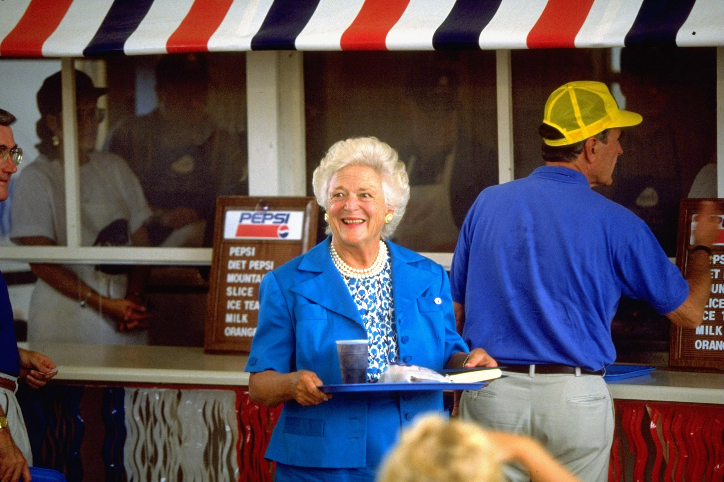 President George H.W. Bush and Barbara Bush patronizing food stand during campaign stop at state fair. August 23, 1992.