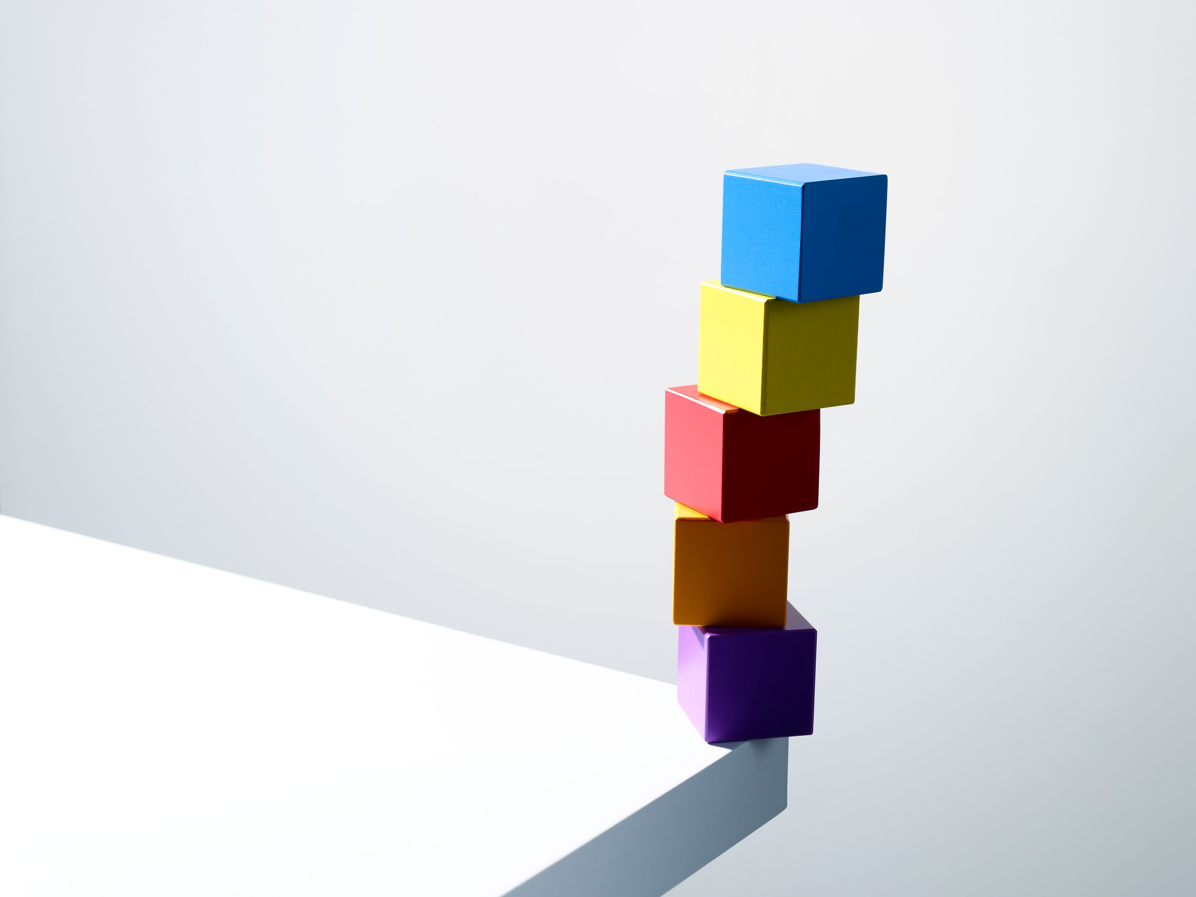 Stack of colorful cubes on table corner