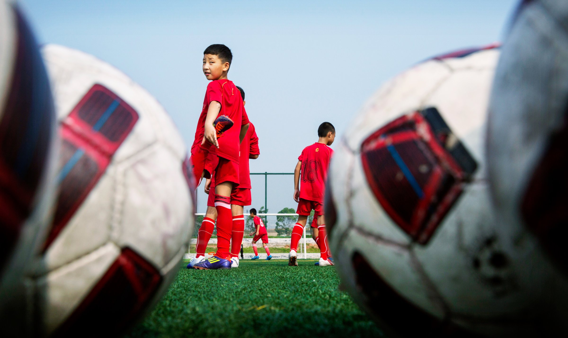 Chinese students wait their turn during training at the Evergrande Football School near Qingyuan