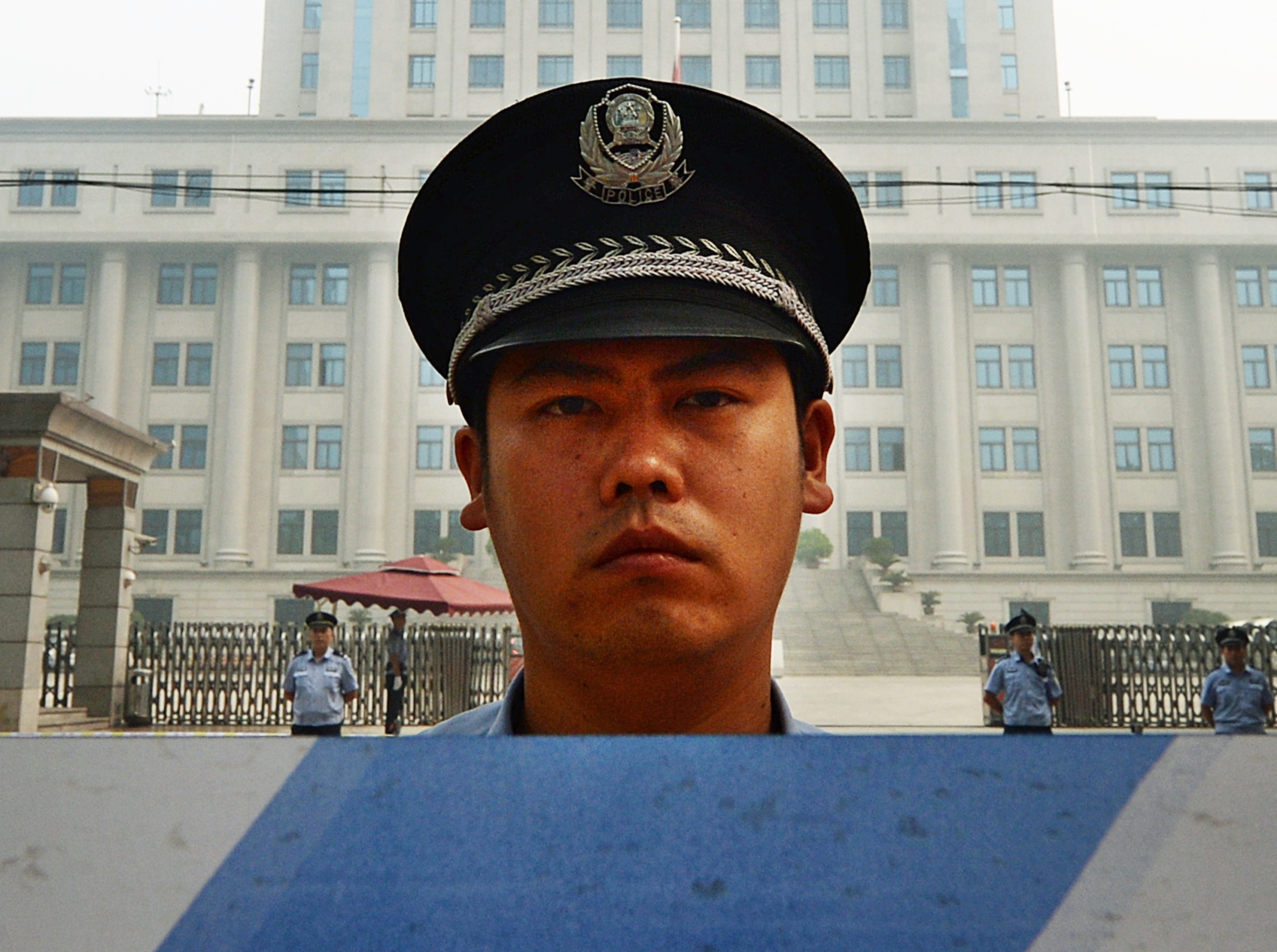 Police stand guard during the third day of the trial of disgraced official Bo Xilai at the Intermediate People's Court in Jinan, Shandong province, on Aug. 24, 2013. (Mark Ralston—AFP/Getty Images)