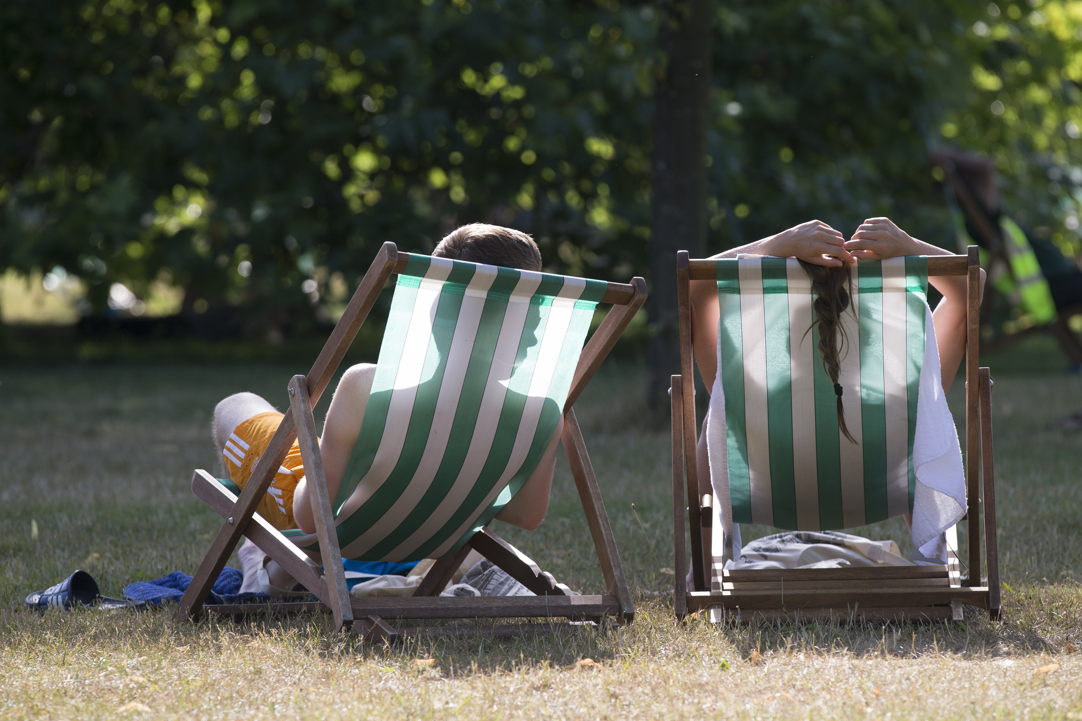 A couple relax on deckchairs in the warm weather in Hyde Park on July 18, 2014 in London as temperatures soar to their highest of the year. (Oli Scarff—Getty Images)