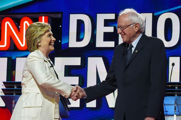 US Democratic presidential candidates Hillary Clinton (L) and Bernie Sanders shake hands before the CNN Democratic Presidential Debate at the Brooklyn Navy Yard on April 14, 2016, in New York.
