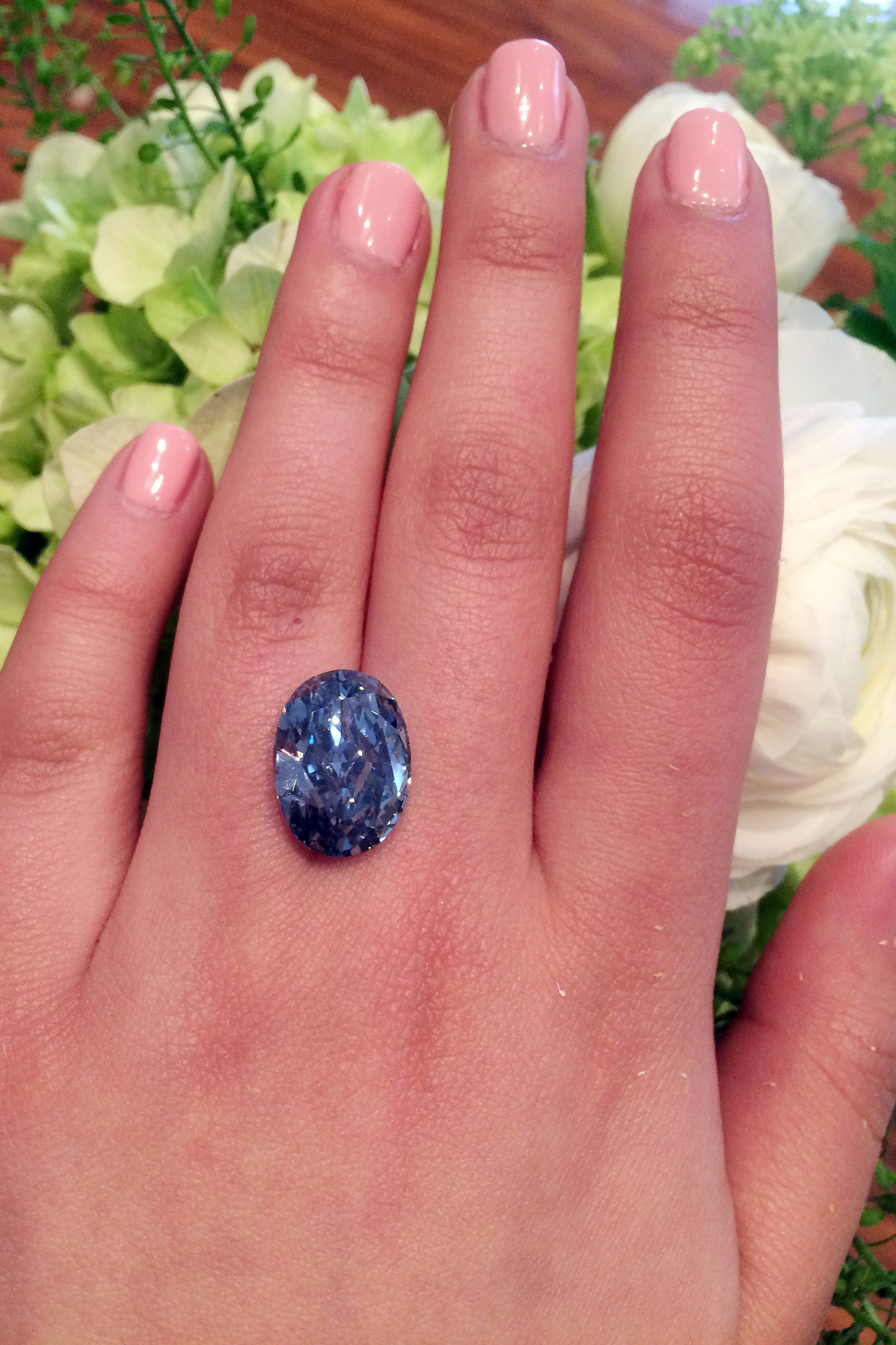 This photo provided by Sotheby's shows a 10.10-carat oval, internally flawless blue diamond. The ‘De Beers Millennium Jewel 4’ is largest oval fancy vivid blue diamond ever to appear at auction.