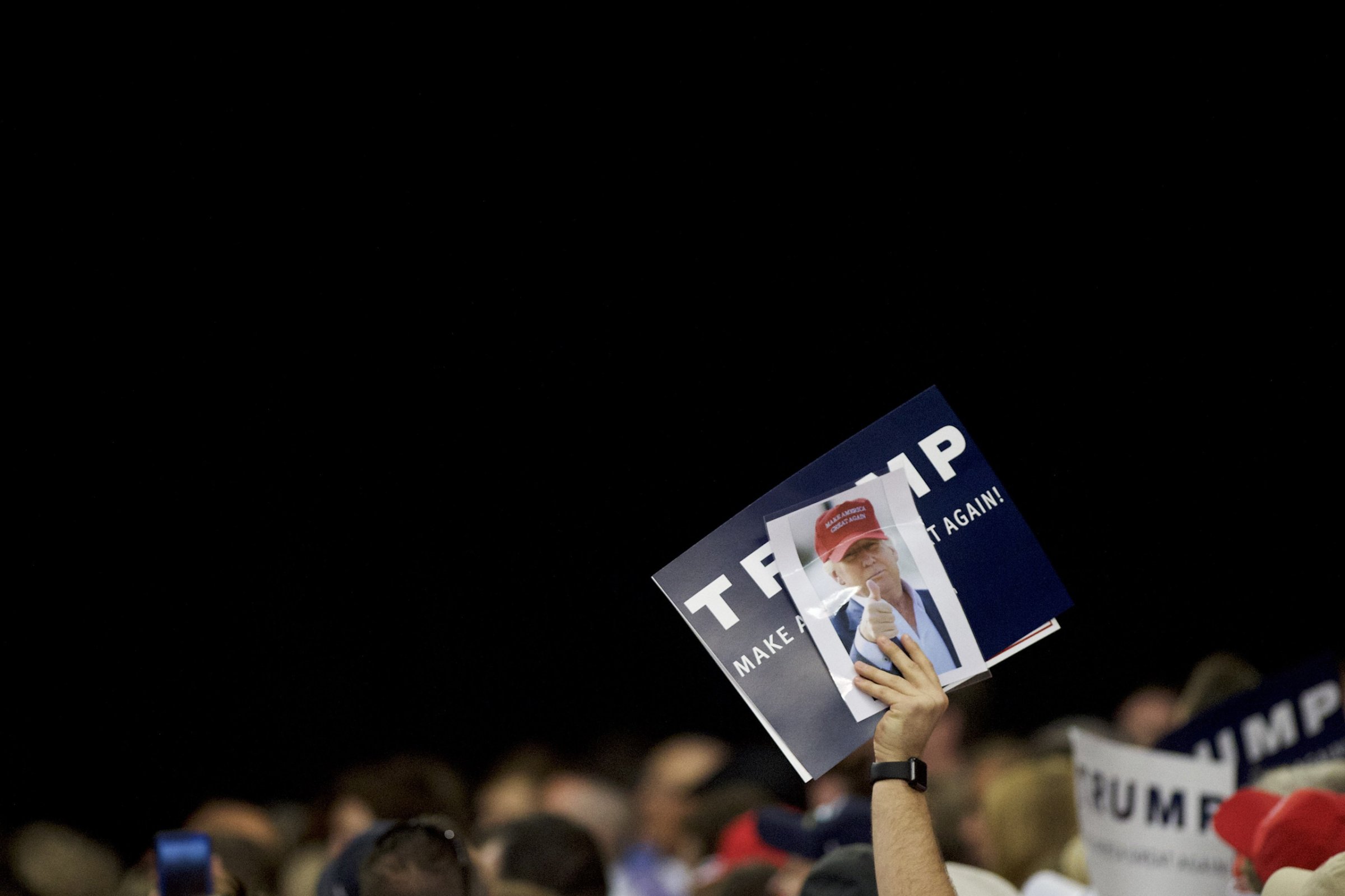 HARRISBURG, PA - APRIL 21: A Donald Trump supporter holds a campaign sign and photograph of the candidate during a rally at the Pennsylvania Farm Show Complex &amp; Expo Center on April 21, 2016 in Harrisburg, Pennsylvania. The Pennsylvania Primary takes place on April 26. (Photo by Mark Makela/Getty Images)