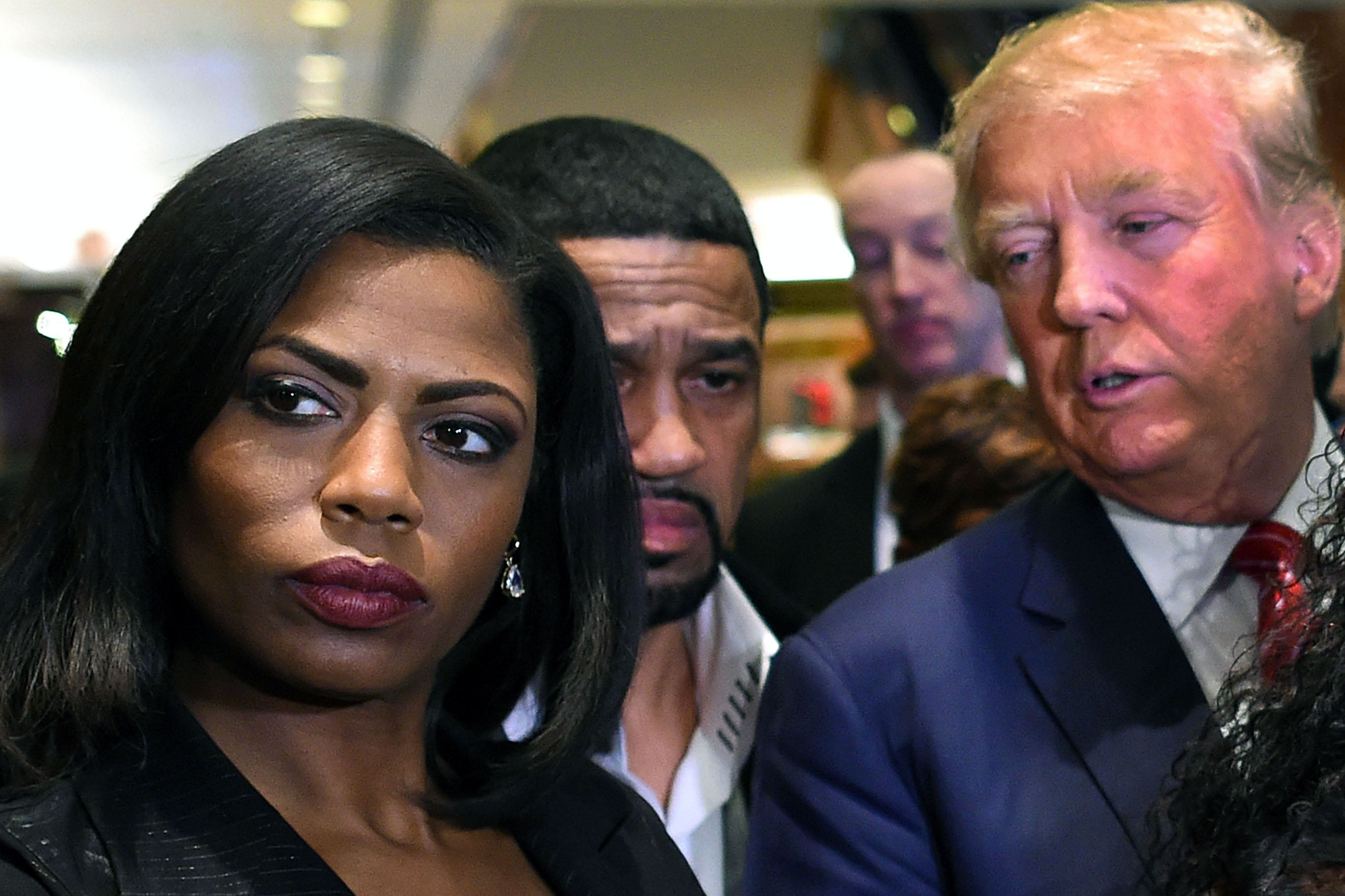 Omarosa Manigault, left, who was a contestant on the first season of Donald Trump's "The Apprentice" and is now an ordained minister, appears alongside Republican presidential candidate Donald Trump during a news conference on Nov. 30, 2015. (Timothy A. Clary—AFP/Getty Images)