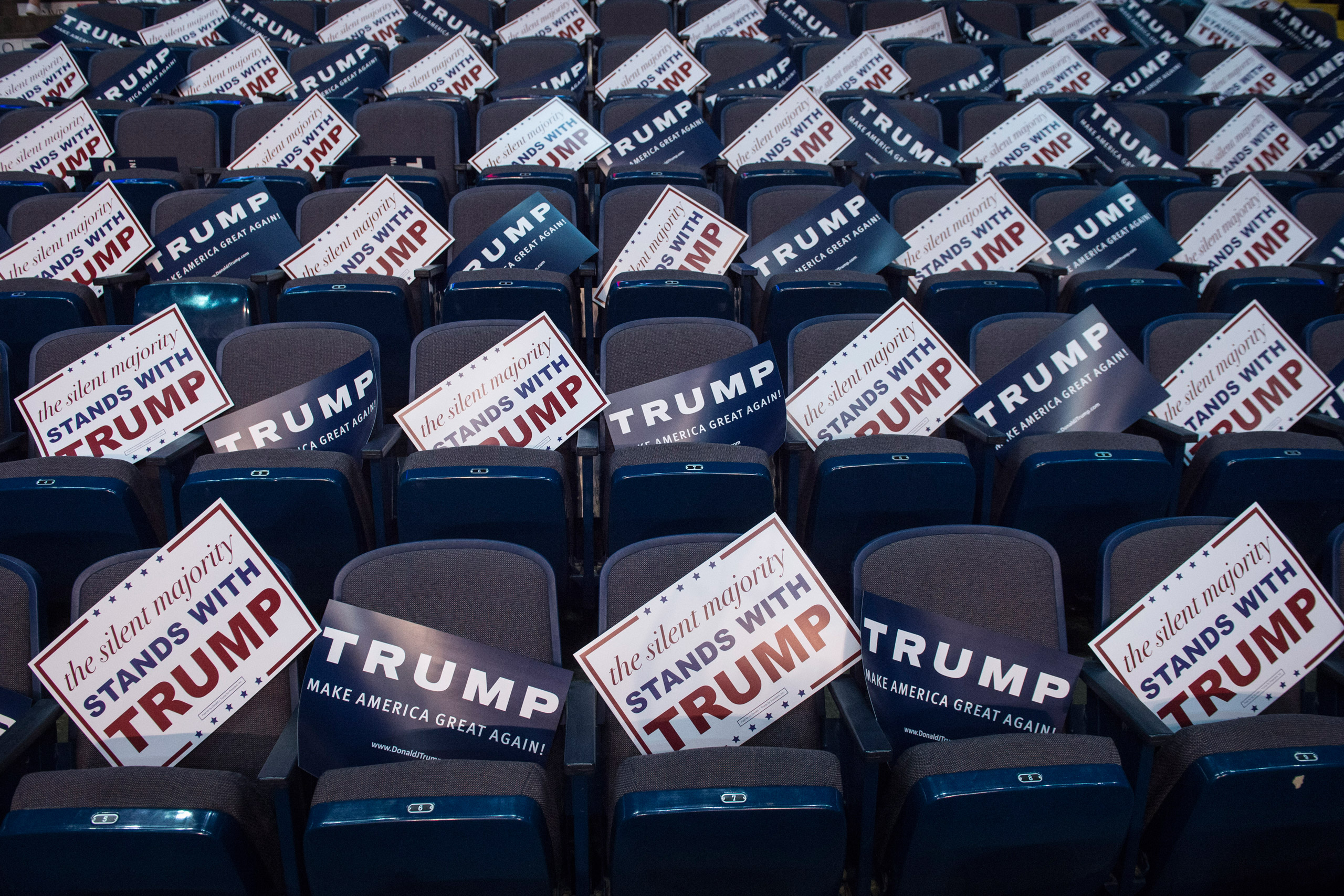 Signs are seen in empty seats before republican presidential candidate Donald Trump speaks during a campaign event at the Times Union Center in Albany, NY on April 11, 2016. (Jabin Botsford—The Washington Post/Getty Images)