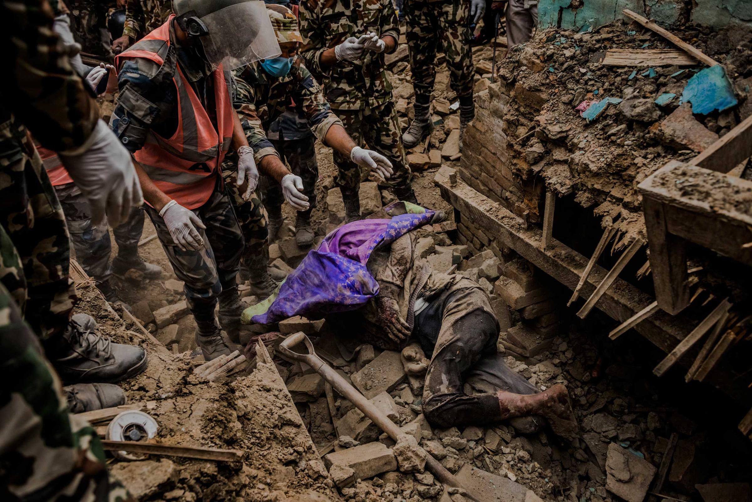 Members of a Nepalese rescue team worked for hours to locate and retrieve the body of an earthquake victim from the ruins of his home in Bhaktapur, Nepal. The April 25 quake killed over 8,000 people and injured more than 21,000. April 29, 2015.