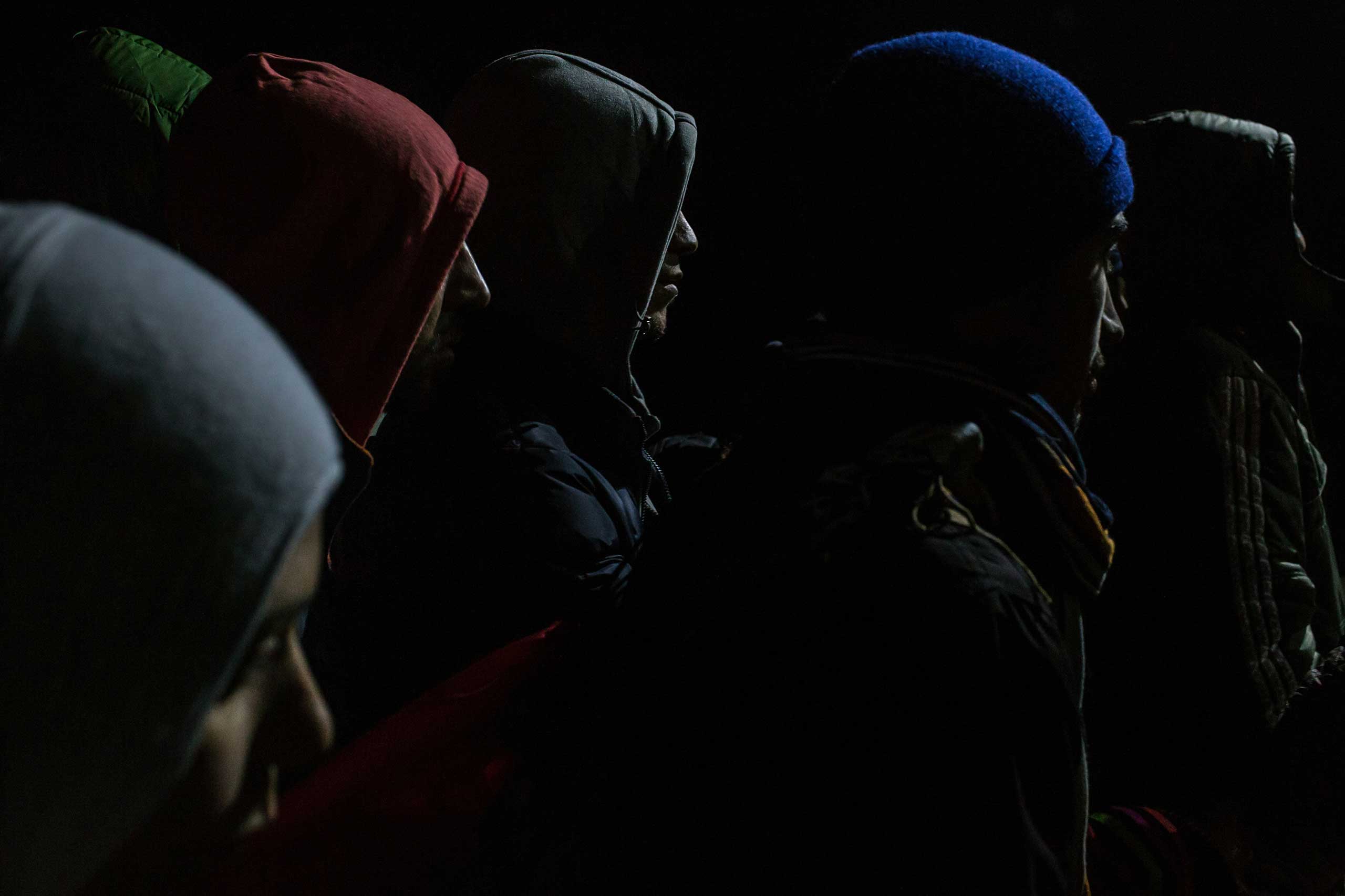 Refugees line up to be registered in a reception camp, in Gevgelija, Macedonia, so they can take a train to Belgrade, Serbia, and continue their journey through the Balkans toward Europe. Nov. 21, 2015.