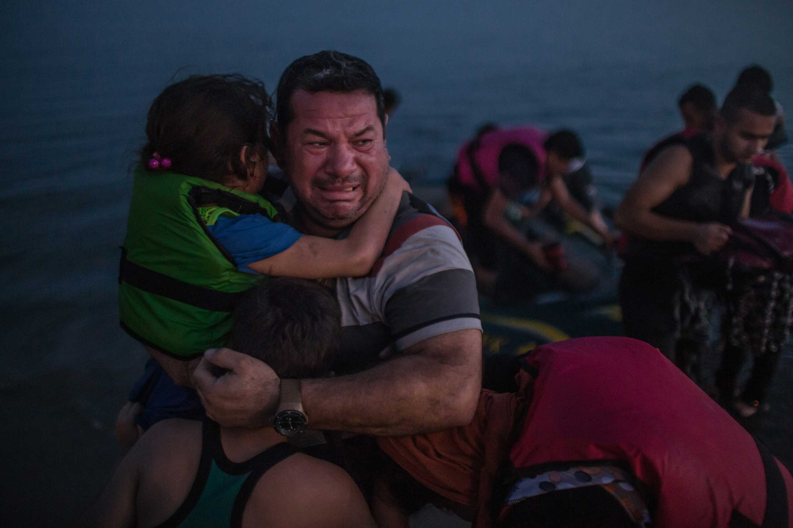 Laith Majid, an Iraqi, broke out in tears of joy, holding his son and daughter after they arrived safely in Kos, Greece, on a flimsy rubber boat. Aug. 15, 2015