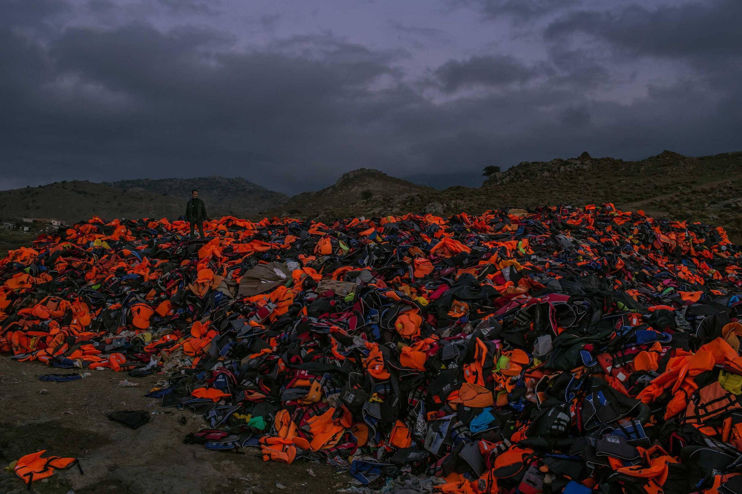A huge pile of discarded life vests, inner tubes and deflated rubber dinghies, the basic equipment that thousands of refugees have using to cross the Aegean sea from Turkey, at dusk on the Greek island of Lesbos. Nov. 7, 2015.