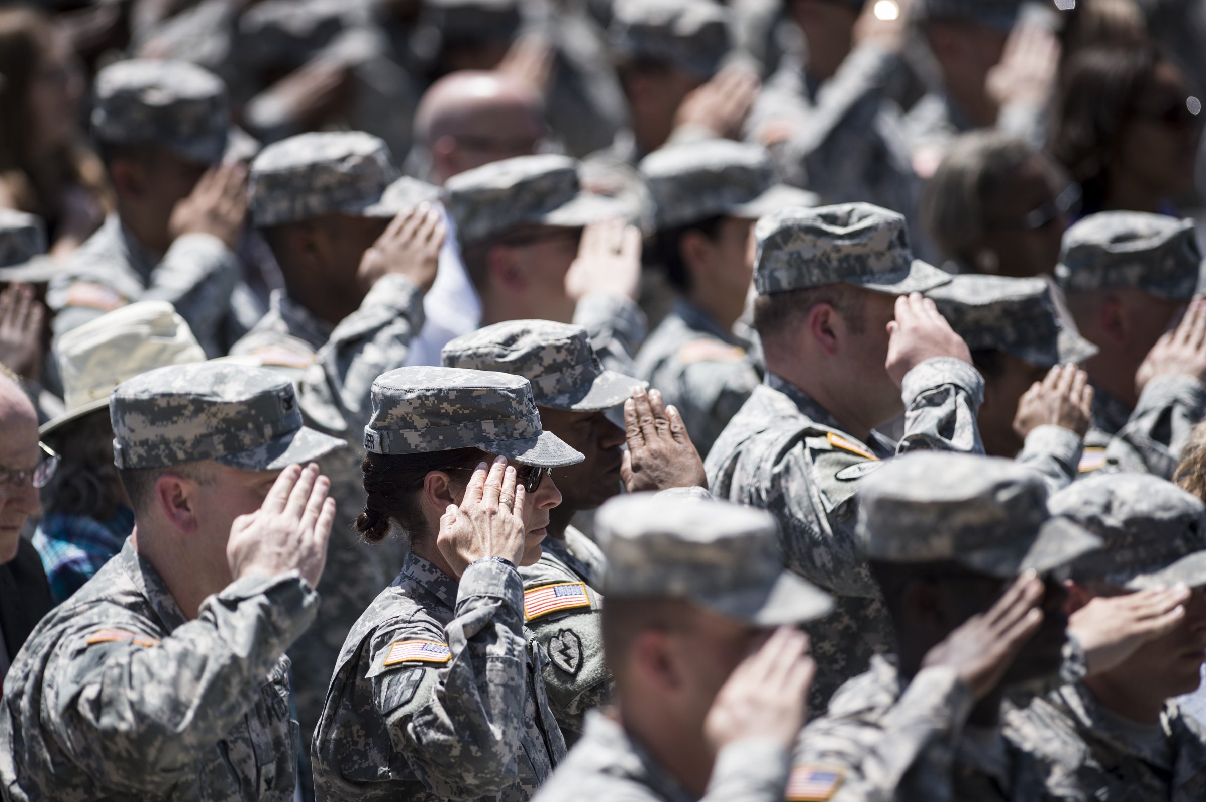 Soldiers listen to the US national anthem during a memorial service at Fort Hood in Texas on April 9, 2014.